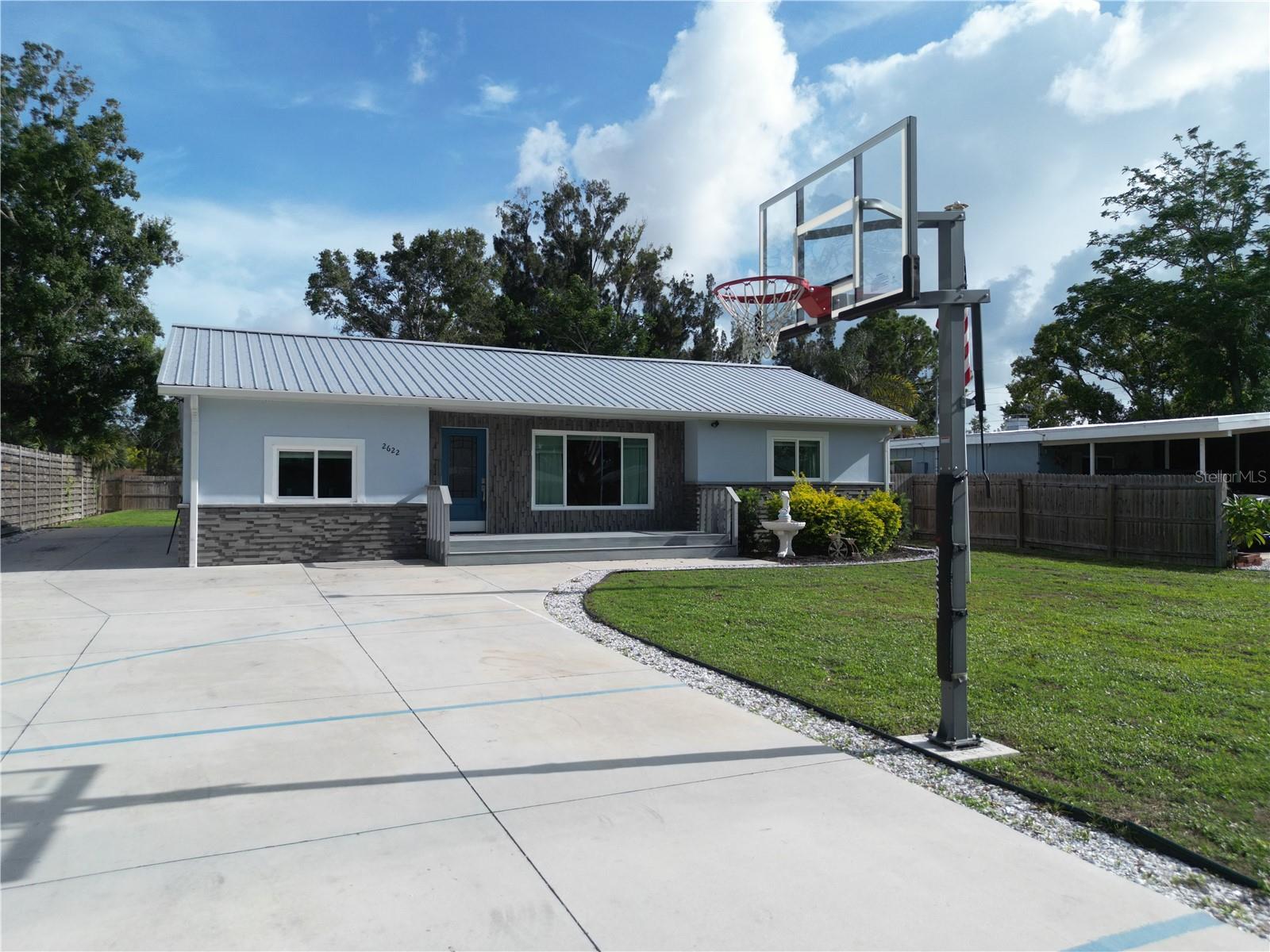 This is the One! *Stunning Fully Upgraded 3-Bedroom, 2-Bath Home Near Riverview High & Siesta Key*Located within walking distance to Riverview High School and just minutes from world-famous Siesta Key, this fully renovated 3-bedroom, 2-bath home is a rare gem with top-of-the-line upgrades and luxurious finishes throughout*Step inside to discover a completely remodeled kitchen and bathrooms, with the kitchen designed as a true chef’s dream, featuring a large center quartz island perfect for entertaining*The master bedroom is a retreat of its own, highlighted by an impressive fireplace adorned with imported Turkish stone*Enjoy peace of mind with a brand-new metal roof and hurricane impact windows throughout. The exterior showcases custom hand-crafted stonework that creates stunning curb appeal*The newly added in-ground pool, surrounded by travertine stone decking, overlooks a spacious, fenced backyard—complete with a half-court basketball area in the front of the house, ideal for both relaxation and recreation*With no deed restrictions, this home offers both freedom and flexibility*Don’t miss this unique opportunity to own a beautifully upgraded home in one of Sarasota’s most sought-after locations*