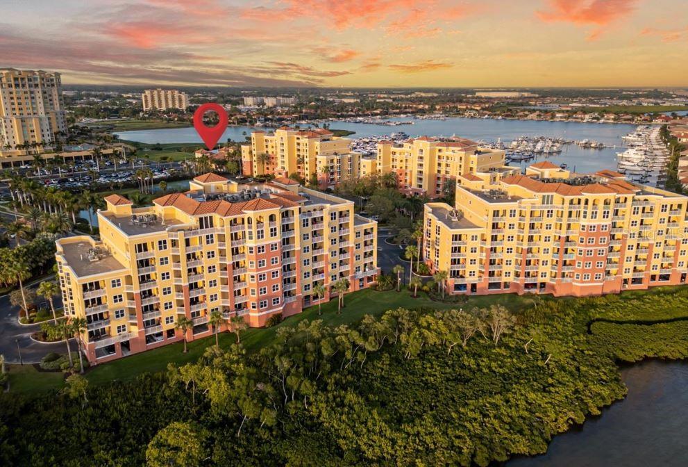 ZERO DAMAGE FROM THE STORMS AND NO FLOOD INSURANCE REQUIRED! The unit has been completely updated inside after a lengthy 2 year remodel. This immaculate two-story penthouse is over 5200 sq ft under roof, and includes a private elevator, 2 balconies, and a 2.5-car garage. This unit was designed to maximize balcony space and completely immerse the owners with river views from almost every room. The upstairs balcony is HUGE. There is an entire area that is OPEN and not covered, so you can enjoy/lounge in the sun. It continues to a covered area, that is great for sunset dinners. There is even a 2nd covered balcony downstairs off the master bedroom and 4th bed/office. The view is always entertaining, with events like the boat races, 4th of July fireworks, and watching the beautiful boats come and go under the green bridge. At night, you can enjoy the city lights and views of the bridge. When you want privacy, just shut the hurricane proof glass sliders, lower the blings, and you will enjoy complete silence. This feels like a 2 story home that was planted on the top of a high rise. The privacy is great. The home has just completed a two year remodel. Practically everything is new! The kitchen cabinets, quartz counters, appliances, sinks, air conditioner, hot water heater, fans, fixtures, vanities, washer/dryer, built in closets, toilets, entertainment wall with fireplace, and even a custom built wine room! The open floor plan offers floor-to-ceiling hurricane impact glass sliders, private interior elevator, his and her bathrooms and closets in the master, a den/office off the master, and more. The Fourth of July will be your new favorite holiday with the view of the fireworks from the balcony. You will get to see the Christmas boat parade as well as the boat races. It's really amazing with all the things that you can see that happen on the river from the balcony. The community amenities include a waterside heated pool and spa, club room, gym, covered pavilion for grilling, tennis and pickleball courts. This popular waterfront community is pet friendly, maintenance-free and allows boat access to Tampa Bay, the Intracoastal Waterway, and the Gulf of Mexico. The Laguna boat dock occasionally has slips available for sale or rent, as does the Riviera Dunes Marina next door. Located minutes to Gulf of Mexico beaches, dining, shopping, hospital, Emerson Point Preserve, Bradenton Riverwalk, Manatee Performing Arts Center, and the Riviera Dunes Dockside Social Bar & Grill at the marina to enjoy live entertainment. Easy access to downtown Sarasota, St. Petersburg, I-75 and I-275 with three major airports less than an hour away. Don’t miss out on this rare penthouse in Paradise.