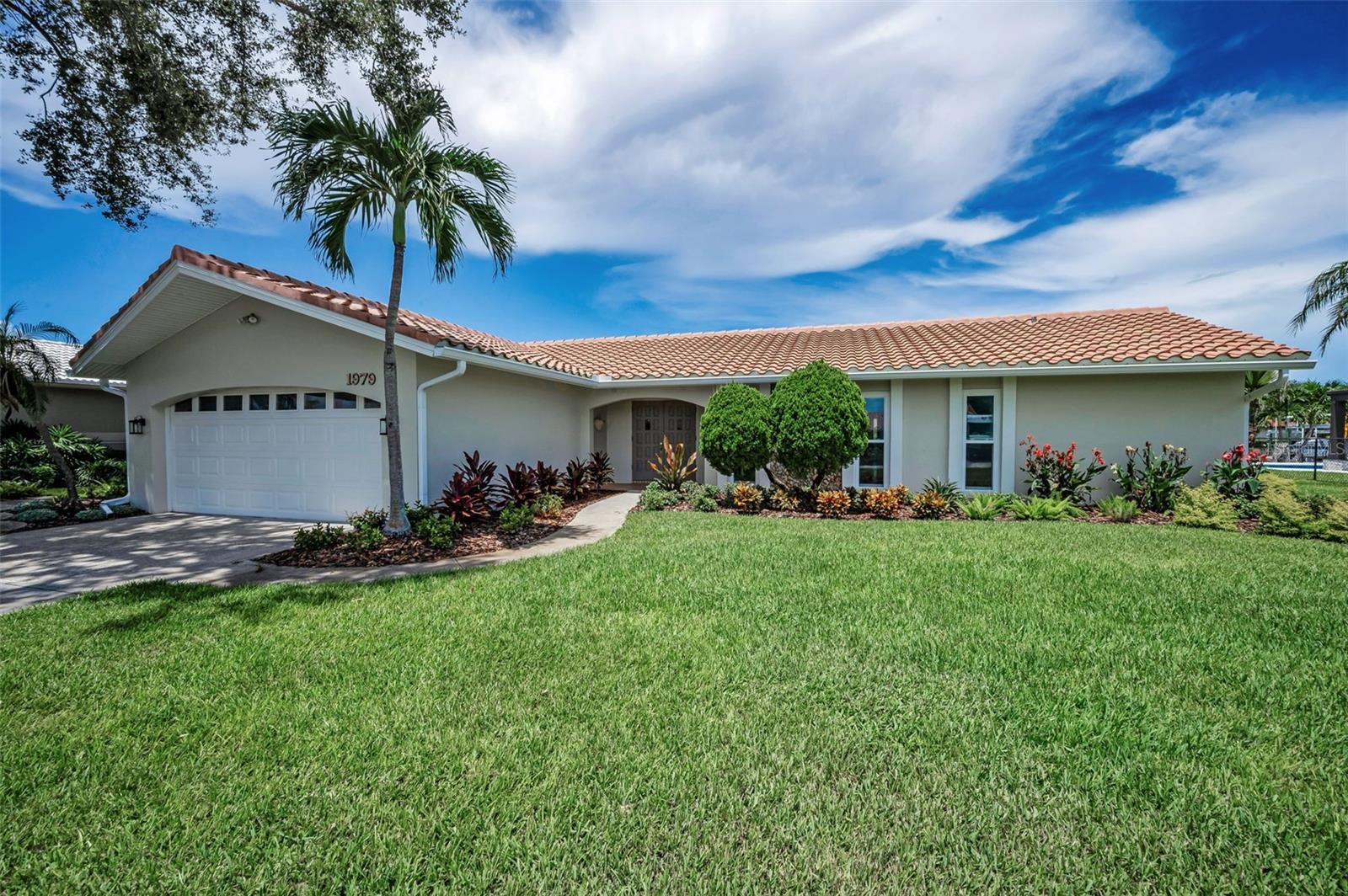 LOCATED IN THE HIGHLY DESIRED VENETIAN ISLES WATERFRONT COMMUNITY, THIS EXCEPTIONAL RESIDENCE BOASTS AN OUTSTANDING, JUST-COMPLETED RENOVATION THAT IS AVAILABLE FOR IMMEDIATE OCCUPANCY. The home features a new 2024 tile roof, impact windows, driftwood-style porcelain floors, 2025 electrical panel and all new electric, new 2025 plumbing, new fixtures, new appliances, repainted inside and out in 2025, and so much more. Beautifully landscaped with an inviting covered entry that transitions to a unique rotunda-like foyer, you’ll love the expansive floor plan that was purposefully-built to focus your life on the waterfront. Overlooking the pool deck, family room and waterfront, the new and resplendent kitchen offers elegant quartz surfaces, shaker-style coastal white cabinetry, a new stainless steel appliance package, gas cooking, a large breakfast bar, recessed lighting, and a passthrough to the pool deck lanai bar. The kitchen supports an attractive dedicated dining room that opens to the pool deck. Your waterfront family room overlooks the water and likewise opens to the covered lanai and pool deck. The large living room provides dedicated access to the pool deck through sliding glass doors that pocket along the wall – creating a perfect indoor/outdoor entertainment and living environment. The private owner’s suite, with roomy walk-in closet, enjoys wonderful views of the waterfront. The gorgeous owner’s bath is completely remodeled with a fabulous custom vanity, superbly-tiled walk-in glass shower enclosure, dazzling floor tilework, and access to a small enclosed courtyard-like area ideal for meditation or greenery. 2nd and 3rd bedrooms are sizable and are supported by a gracefully-appointed bath containing a large dual vanity with quartz surfaces and shaker style cabinetry, recessed lighting, and alluring tile finishes. The home includes generous closet storage and a spacious indoor laundry room. You’ll also appreciate the seamlessness of classic “Cove” moldings join textured ceilings to rich wall finishes. Step out back to the huge 450 sqft covered lanai with numerous areas for seating, dining and lounging. The pool, with new pool pump and pool sweep, is contained within a large screen enclosure that helps keep your pool clean of debris. With no bridges to limit your boating options, you can reach open Tampa Bay from here in less than a minute. This home is the definition of move-in ready and is in a great location near fine shopping, dining and excellent K-12 schools. Measurements are estimates, buyer to verify.