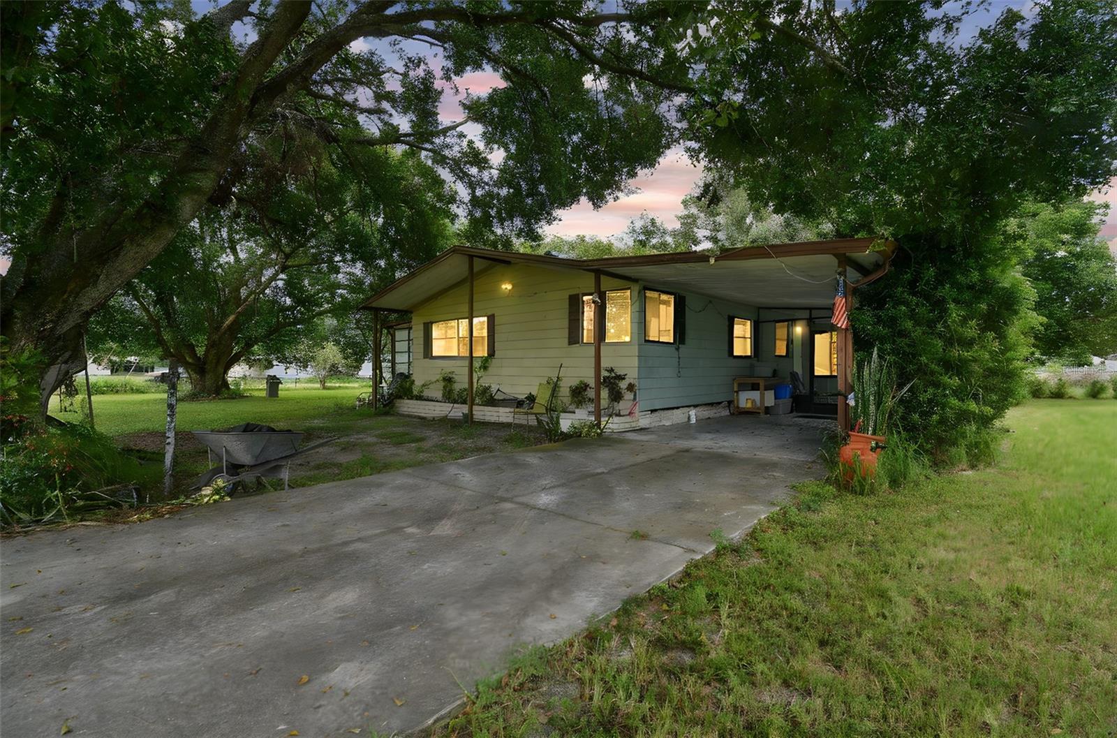 This 2-Bedroom, 2-Bath manufactured home sits on its own land, offering just under an acre (0.9 acres) of space, privacy, and possibilities. Whether you’re looking for your next investment, a renovation project, or a home you can customize to your vision, this is the handyman special you’ve been waiting for.
Step inside to find a good-size family room open to the dining room and kitchen, creating a flexible main living space. The home features laminate flooring throughout, a glass porch with cement flooring—perfect for relaxing with a book—as well as a screened patio for enjoying Florida’s sunshine year-round. Down the hall, you’ll find an office space, two secondary bedrooms, and the primary bedroom with a large window and private bath with shower.
Set on a corner lot fully enclosed with chain link fencing, this property also includes a shed for storage and plenty of room for gardening, pets, or outdoor projects. The location offers the best of both worlds: a quiet setting with easy access to shopping and highways, making convenience part of your everyday lifestyle.