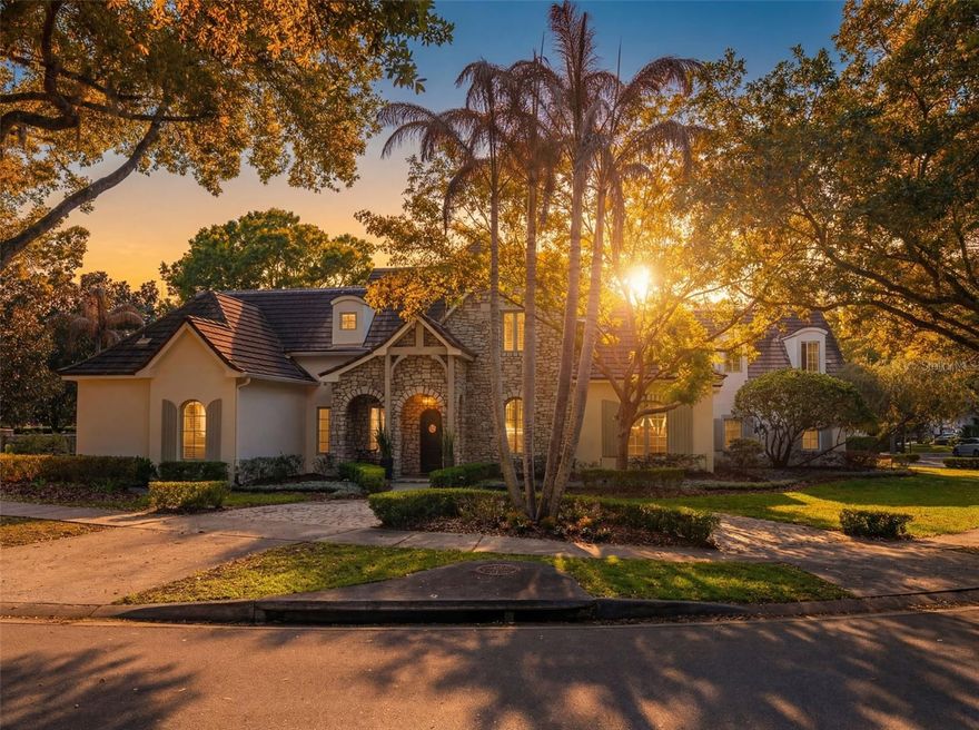 Tucked within the prestigious enclave of Windsong Lakeside in Winter Park, this extraordinary estate is a masterclass in refined living—where thoughtful design, cutting-edge technology, and timeless elegance converge. From the moment you arrive, the circular drive and stately presence set a tone of quiet grandeur. Step inside, and the home unfolds with an effortless sense of scale, defined by soaring vaulted ceilings and an abundance of natural light filtering through custom windows. Every detail has been meticulously curated—from the rich new flooring installed in 2025 to the soft glow of Currey & Co. lighting that adds warmth and sophistication to each space. Designed for both comfort and control, the residence is fully integrated with a wireless home automation system, allowing seamless management of lighting, climate, security, and more. Three A/C units ensure optimal comfort, while a new tankless water heater, water softener, and whole-home surround sound system elevate everyday living. A comprehensive security camera system and ADT Home Control provide peace of mind with modern convenience. Each of the four bedrooms is a private sanctuary, complete with its own en-suite bath, offering an elevated sense of privacy for residents and guests alike. The primary suite is a retreat unto itself, featuring custom built-in storage and electric storm shutters with blackout capability. The spa-inspired primary bath showcases a dual Grohe shower system, thermostatic auto tub filler and integrated TV - creating an environment of indulgence and serenity. At the heart of the home lies a newly renovated (2025) chef’s kitchen—an exquisite blend of form and function. Outfitted with premier appliances including a Wolf six-burner gas range, Sub-Zero refrigerator, Monogram built-in microwave, and dual dishwashers, the space is designed for both intimate meals and grand entertaining. Custom cabinetry with integrated lift features, dual sinks, filtered water dispenser, and elegant stone countertops complete this culinary haven. The living room invites relaxation with its newly renovated gas fireplace (2025), while a dedicated office offers bespoke built-in cabinetry with marble surfaces and glass shelving—ideal for sophisticated work-from-home living. Upstairs, the home transforms into an entertainment destination, complete with a projector theatre setup, wet bar, additional powder bath, and extensive storage. A dedicated A/V closet and the potential for an upstairs laundry add both function and flexibility. Outdoors, a private resort-style oasis awaits. The backyard has been completely reimagined, featuring lush turf, a sun deck platform, and even an in-ground trampoline—blending luxury with playfulness. The saltwater pool and spa, enhanced with upgraded LED lighting and a new heater (2025), were fully refinished and redesigned in 2021 to create a serene and visually stunning escape. A fully equipped summer kitchen—complete with a built-in gas grill, dual burners, refrigerator, and screened enclosure—sets the stage for unforgettable gatherings under the Florida sky. The three-car garage is equally impressive, featuring a Wallbox Level 2 electric vehicle charger (2023), seamlessly blending luxury with modern sustainability. This is more than a home—it is a statement of lifestyle, craftsmanship, and elevated living in one of Central Florida’s most sought-after lakefront communities.