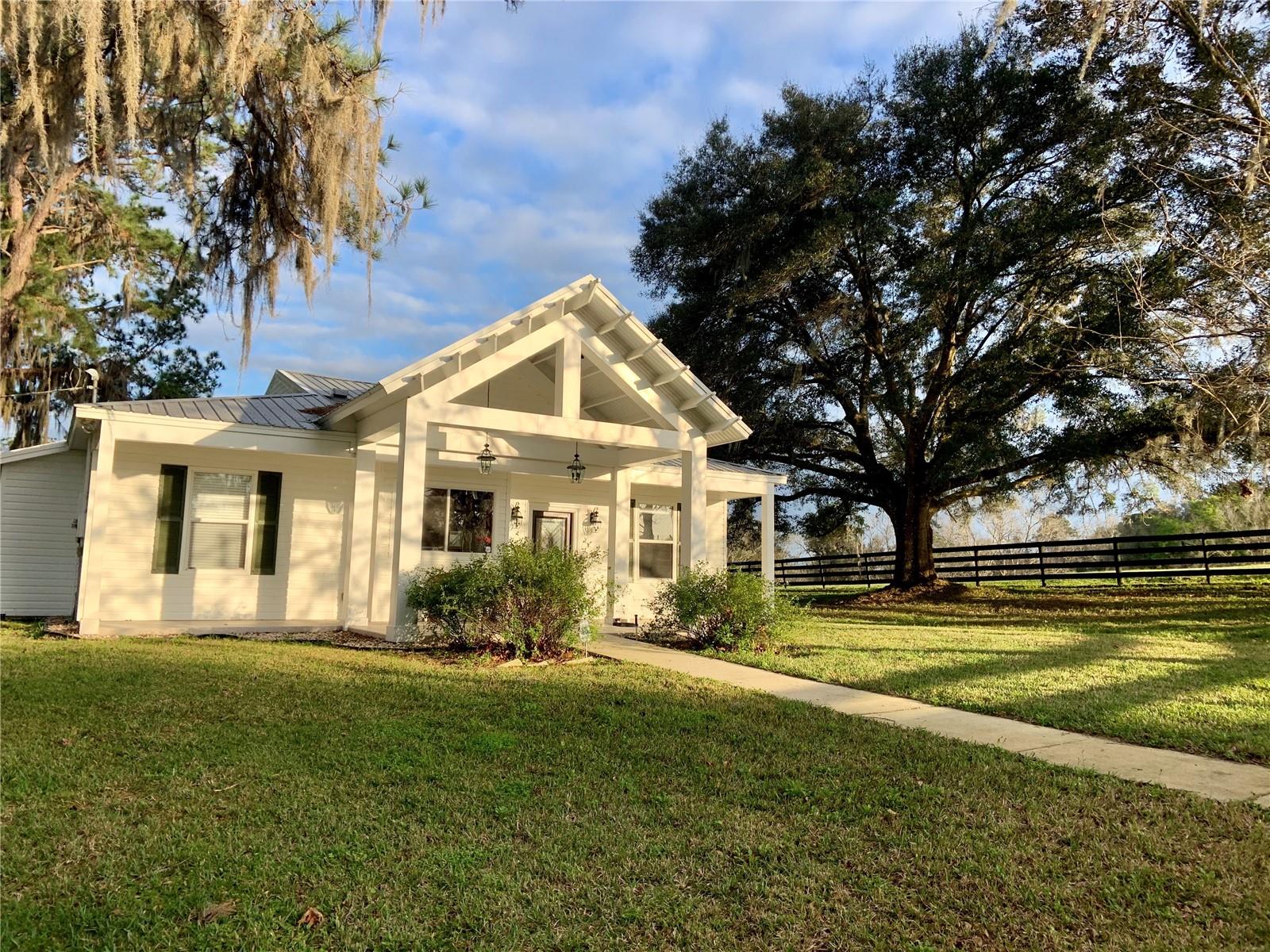 This Magnificent 79 acre working cattle ranch, known for it's pure water and fertile soil, is divided into 7 large parcels providing endless possibilities for the buyer. Avid equestrians will appreciate the facilities in place which include a brand new 20 stall horse barn, cattle pen, horse riding arena, equipment barn, hay barn, five naturally spring fed ponds, abundant wildlife and extensive wooded riding trails.
On this gorgeous property you will find two homes which have both been remodeled and upgraded. The main home features a soaring ceiling with wood beam accents, an open split floor plan and tile flooring throughout. Beautifully updated gourmet kitchen with pull-out shelving and 3 en suite bedrooms with private baths. Two of the bedrooms open onto the relaxing large screened lanai thru French doors.
In the Cottage/Studio which is adjacent to the main home you will find a two bedroom, two bath guest house which includes a full kitchen, spacious living area/event space, full bath and office on one side plus two bedrooms, full bath, kitchenette and additional living quarters on the other side. The cottage guest suite is brand new top to bottom. 3 triple sliders open to a large 40’ x 16’ composite deck from the studio/event area.
A 46'x25' building can house farm equipment or recreational vehicles. Four board fencing surrounds the property and sections off numerous pastures; most gates include remote access. Only the highest quality of Tifton 44 grass can be found in these pastures for both grazing and hay production. A 60' X 40' drive-thru hay barn capable of sustaining 140 mph winds is located by the horse arena. Trails for walking, riding and ATV's.
This is a rare and unique opportunity to purchase an ideally located turnkey property which includes all the furnishings and equipment for running the ranch as well as an event venue, along with the owner’s current inventory of farming equipment, machinery and livestock.
Other notable features of this property include: newer HVAC system, new electrical box/service hub in main house & tractor barn, new well pump, wiring & piping, metal roof, alarm system and Alert360 exterior cameras on porches, cedar ceiling and walls in studio, seamless gutters with gutter guards, 50 amp RV line, new hot water heater in cottage, Zoned AG, this property can offer both investment and lifestyle returns. Some income producing opportunities include horse boarding, trail rides, riding lessons, training, cattle sales, turkey hunting, Air BnB, hay sales, U Pick berry farm, wedding venue, corporate retreats, family events such as birthday parties, bridal & baby showers & wellness center including Yoga, Pilates and other wellness classes.