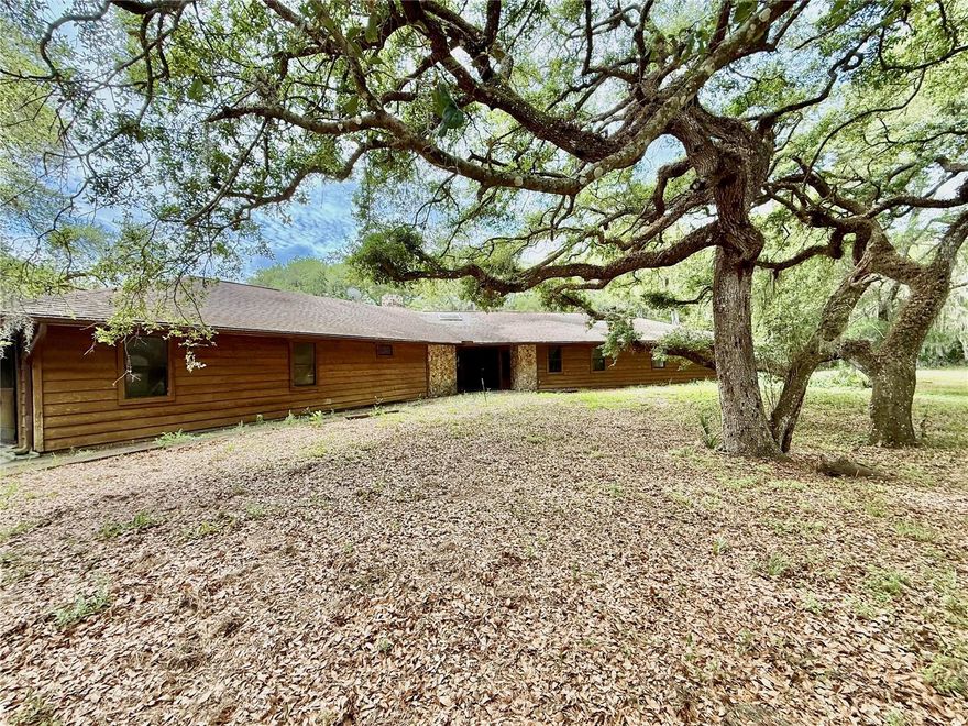 Welcome to your own private slice of country living with almost 5 acres of peaceful, open land where country living meets everyday comfort. This property provides a serene retreat while remaining just minutes from New Smyrna Beach, Edgewater, local parks, river, boat ramps and popular biking/walking trails. Enjoy the quiet life in this 3 BD 2.5 BA custom built unique home with large rooms, it is a must see! A renovated kitchen showcases modern updates and flows effortlessly into the dining area, creating a great space for everyday living or entertaining. Huge stone fireplace can warm the entire living area in the winter. House has generator & water softener. Back of the house has a neat wrap around screened porch overlooking mature trees, open green space and quiet rural scenery. This home is just waiting for its new owners to bring it back to life. Property is fenced with a gate at the drive ready for you to bring your live stock and plant your gardens. Offers the freedom of no HOA and captures the true essence of rural Florida living. The perfect location (No HOA) for anyone who owns needs to park equipment, trucks, an RV or any other type of vehicle on the property. New roof to be installed soon. Please note that all measurements and information are deemed accurate but should be verified by the buyer.