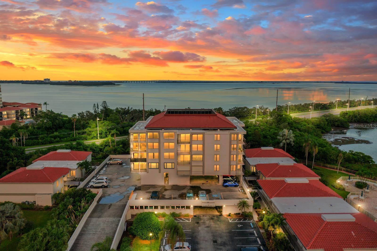 Magnificent sunsets, panoramic and breathtaking bay, nature and golf course views from your private balcony! Beautiful updated 6th (highest in building) floor 2-bedroom, 2-bathroom condo in the residential neighborhood of Bayway Isles in St Petersburg. Seamless open-plan design ideal for entertaining, allowing guests to flow effortlessly from the spacious living area to the large kitchen and to the private balcony. Abundant natural light throughout the open floorplan. The kitchen is a chef's dream, complete with stainless steel appliances, volume cabinet space, and expansive Granite counter space with easy access to guests with the large breakfast bar and convenient location next to the dining area. Enjoy peace of mind with the touch of a button thanks to conveniently operated ELECTRIC HURRICANE SHUTTERS- does not come with units- Owner had them CUSTOM INSTALLED. HVAC 2021. ONE ASSIGNED GARAGE PARKING SPACE. Additional features- inside unit closet laundry and extra closet space. No walking upstairs- this building has an ELEVATOR. POOL and SPA overlooking the bay and large recreation room available for residents to host functions and gatherings. Perfect retirement, vacation or investment condo! Adjacent to Isla Del Sol Yacht and Country Club golf course- membership required. Conveniently located close to St. Pete Beach, Fort DeSoto Park, Downtown St. Pete, 30-minute drive to Tampa International Airport, dining, shopping and entertainment! LENDER INCENTIVE/CONCESSION AVAILABLE FOR BUYERS. Call for details. VISIT OUR 3D TOUR.