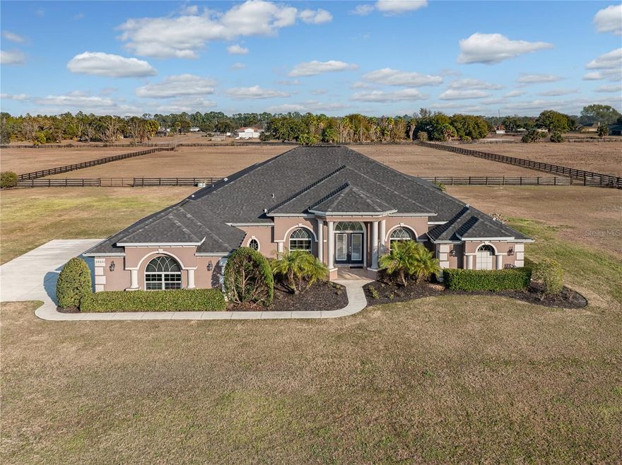 Experience Luxury Country living on this stunning 5-ACRE estate in Tavares, Florida. Built in 2019, this custom 4-bedroom, 3-bath pool home offers the perfect blend of elegance, privacy and functionality - fully fenced and ready for horses or your favorite outdoor hobbies. Step inside to an inviting open layout featuring soaring 10-ft ceilings, abundant natural light, and premium finishes throughout. The gourmet kitchen is the heart of the home, showcasing expansive countertops, high-end cabinetry, and generous space for cooking and entertaining. Relax in the spacious primary suite, unwind by the sparkling pool, or enjoy the wide-open acreage ideal for equestrian lovers, gardening, or simply enjoying the ultimate privacy. Enjoy the Florida lifestyle with a sparkling pool, expansive outdoor space, and room to create the property of your dreams. The HOA allows two additional buildings, giving you the freedom to add a barn, workshop, RV garage, or storage for all your toys. Located just minutes from downtown Mount Dora and the Harris Chain of Lakes, this property offers quick access to charming shops, dining, and world-class boating and fishing—while still providing the privacy and tranquility of acreage living.
A rare opportunity to own a modern luxury home with land, flexibility, and an unbeatable location.