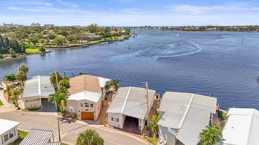 Enjoy stunning panoramic views of Roberts Bay from three hurricane-rated sliding doors. Watch dolphins, manatees, and seabirds from your own backyard! Opportunity to add a boat lift or dock in this sailboat water access and take a 5-minute ride to the Gulf of Mexico — no bridges!
This home features a large deck for dining, entertaining, and relaxing while overlooking the bay. Electric retractable Sunbrella awnings provide shade, and the sunsets are nothing short of spectacular.
Inside you’ll find 1,400 sq. ft. of open living space, 2 bedrooms, 2 full baths, and brand-new porcelain tile. The kitchen boasts granite countertops, newer appliances, and a great flow into the dining and living room. The guest room doubles as an office with a Murphy bed. The home also includes a full-size laundry room, mirrored walls to reflect water views, and a built-in wet bar.
Additional upgrades include newer A/C, track lighting, and a large covered carport with paver driveway, tool/work room, and storage.
Located in a vibrant 55+ waterfront community with low HOA fees, resort-style pool, tennis, clubhouse, and daily activities. Move-in ready, meticulously maintained, and perfect for entertaining — watch fireworks from your deck. Enjoy and easy walk across the Venice Bridge and stroll through Downtown Venice Ave. Pets are welcome!