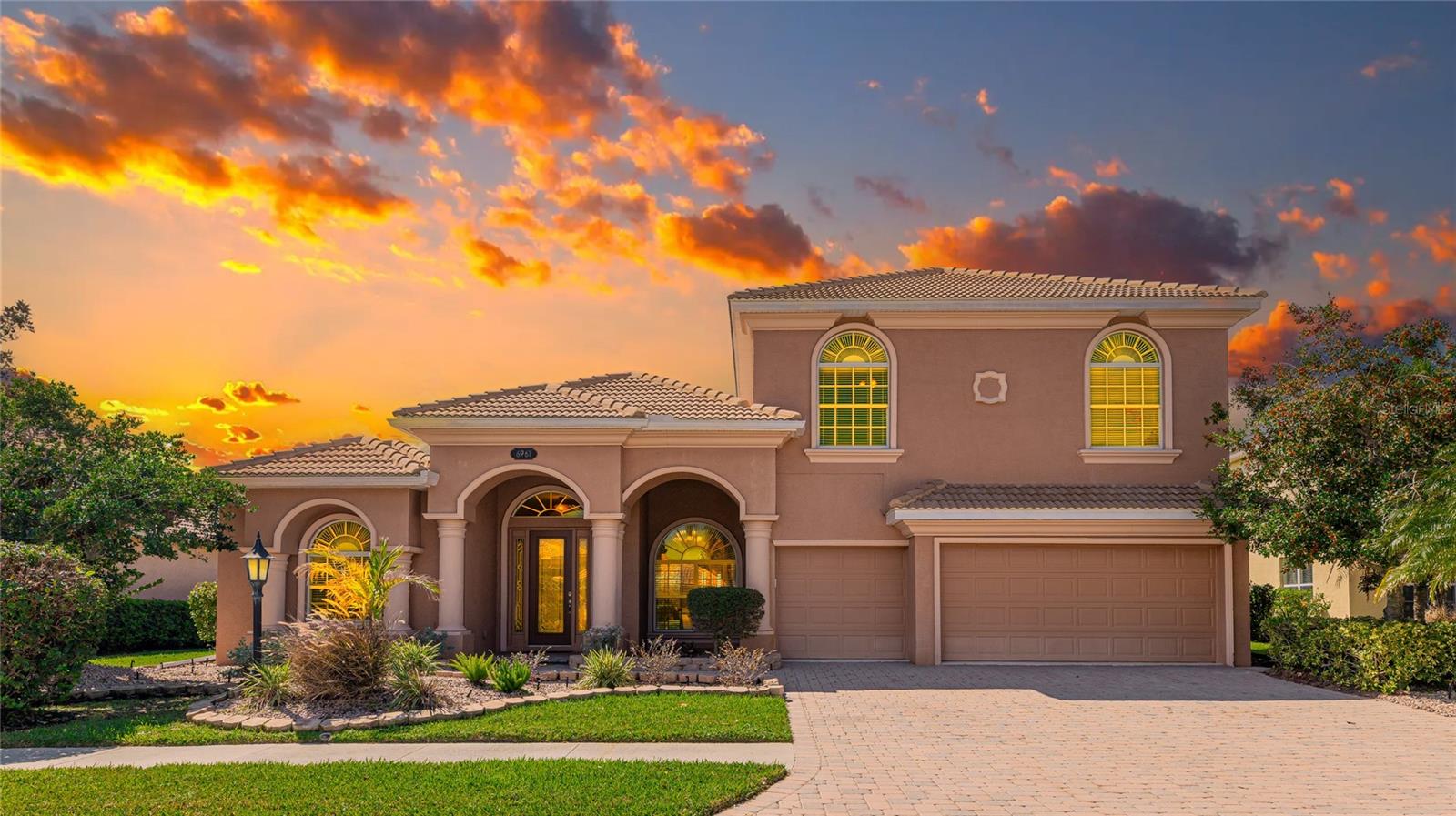 One or more photo(s) has been virtually staged. Welcome to 6961 Scrub Jay Drive, an exquisite lakefront estate in the highly sought-after Red Hawk Reserve community! Situated on a premium homesite, this meticulously upgraded home defines luxury living with nearly 4,200 sq. ft. of elegantly designed space. The Grand Chatham LSV model was built by the Luxury Division of US Homes—No CDD Fees! Breathtaking Sunset & Lake Views!
Boasting 4 spacious bedrooms, 4 bathrooms, a dedicated office/study, a versatile studio or 5th bedroom, and a massive 400+ sqft bonus Room upstairs, this home offers both comfort and functionality. The gourmet kitchen is a chef’s dream, featuring designer cabinetry with crown molding, a custom wood range hood, under-cabinet lighting, a center island with breakfast bar, and high-end stainless steel appliances. A bright and airy dinette, framed by an expansive aquarium window, provides the perfect backdrop for enjoying your morning coffee while overlooking the inviting pool and tranquil lake. With four massive sliders and expansive windows, this home offers a truly immersive experience—enjoy breathtaking sunsets and panoramic views of the lake and pool from nearly every angle.
The primary suite is a true retreat, showcasing breathtaking views of the lanai and pool, along with two custom walk-in closets. The spa-like en-suite bath offers a Roman shower, soaking tub, and dual sinks, creating the ultimate relaxation experience. Three additional bedrooms feature high-end custom closet systems for optimal organization. Upstairs, a sprawling 28’x15' bonus room provides endless possibilities—ideal for a media room, game room, or additional living space.
Step outside into your private tropical oasis, where a wrap-around lanai with brick pavers frames a heated pool and spa, all overlooking the serene lake. The oversized 3-car garage is designed for convenience, featuring built-in storage solutions and overhead racks.
Located in the coveted A-rated school district, Red Hawk Reserve is just 6 miles from world-famous Siesta Key Beach. The community offers peace of mind with a virtual guard gate, high-resolution security cameras, well-lit sidewalks, and reclaimed water irrigation.
This is your chance to own a piece of paradise! Don’t miss out—Experience the 3D Matterport Walkthrough and schedule your private tour today!