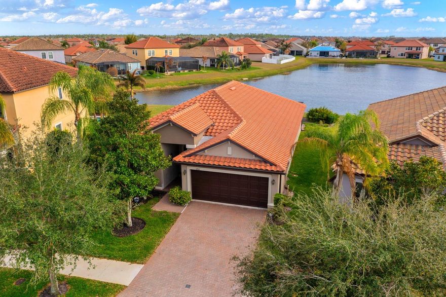 Breathtaking pond views from your private screened lanai make this beautiful move-in ready home in Riverview, Florida truly stand out. Offering 2,065 square feet of living space, this 2016 construction home blends modern design, quality upgrades, and a lifestyle-focused community in one of Riverview’s most desirable gated neighborhoods.
From the moment you arrive, the home delivers impressive curb appeal with a striking Barcelona tile roof, brick paver driveway, and welcoming covered front porch. Inside, the spacious open floor plan creates a seamless flow between living, dining, and kitchen areas—perfect for everyday living and entertaining.
The upgraded kitchen is a centerpiece of the home, featuring stone countertops, staggered wood cabinetry, designer tile backsplash, and stainless-steel appliances. Generous room sizes throughout the home provide both comfort and flexibility for modern living.
Step outside to the screened lanai overlooking the tranquil pond, creating a peaceful outdoor retreat ideal for relaxing mornings or evening gatherings. The back slider is also equipped with FORTRESS hurricane screens, offering additional protection and peace of mind during Florida’s storm season. (All windows are equipped with custom FORTRESS HURRICANE SCREENS)
Located in a gated Riverview community, residents enjoy resort-style amenities including an open-air amenity center, scenic walking and hiking trails throughout the neighborhood with built-in fitness stations, and smart home technology with included internet service for convenience and connectivity.
If you’re searching for a Riverview home with water views, modern upgrades, and resort-style community living, this property delivers the perfect combination of comfort, style, and location.