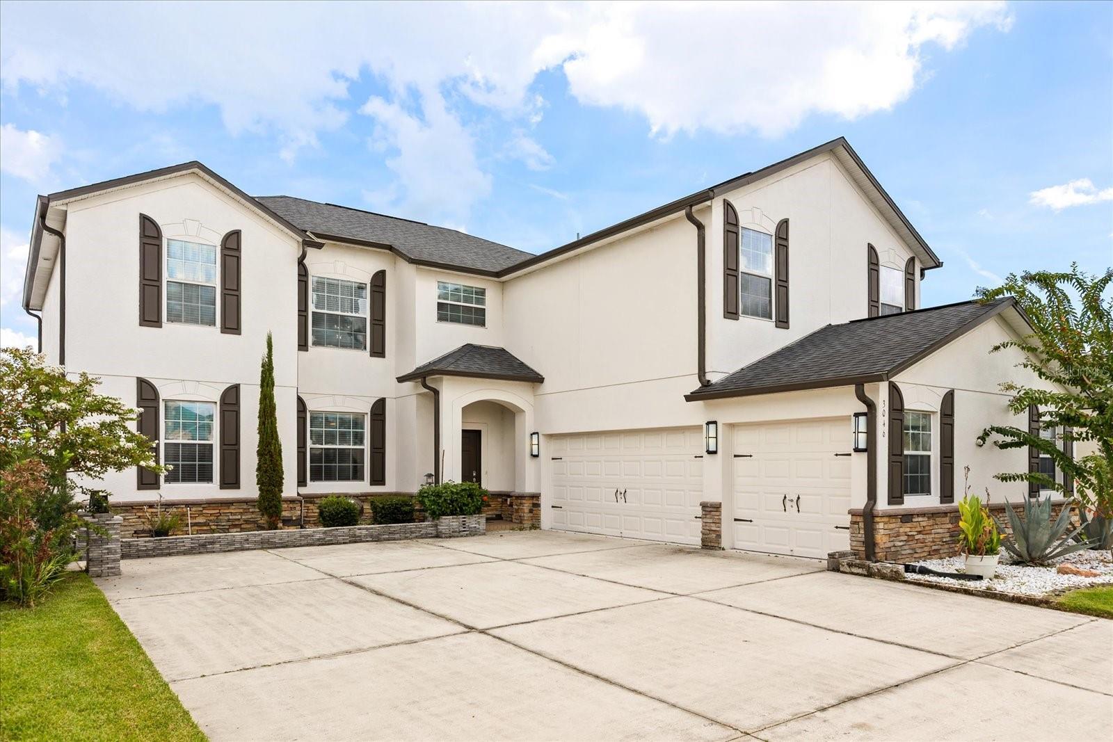 Beautiful Waterfront Home in Wyndham Lakes Estates , this spacious two-story home offers 5 bedrooms, a BONUS room, 3 bathrooms, and a 3-car garage in one of South Orlando’s most desirable communities. On the first floor, you’ll find an elegant kitchen with stainless steel appliances, 42” dark cabinetry, granite countertops, and a cozy eat-in space. The layout also includes a separate dining and living room, a large family room perfect for entertaining, and two oversized sliding doors that open to serene waterfront views. For added convenience, there is also a bedroom with a full bathroom downstairs, ideal for guests or multi-generational living. Upstairs, the generous primary suite features two walk-in closets and a spa-like bathroom with dual sinks, a garden tub, and a separate walk-in shower. Three additional bedrooms with water views, along with a versatile bonus room, perfect as a media room, playroom, office, or dream closet, complete the second floor. Step outside to the covered porch and enjoy peaceful water views in your own backyard retreat. Wyndham Lakes Estates offers resort-style amenities including a clubhouse, fitness center, aerobics room, swimming pool, playground, basketball courts, and tennis courts. The location is unbeatable, just minutes from Orlando International Airport, Medical City, major theme parks, shopping, and dining.
