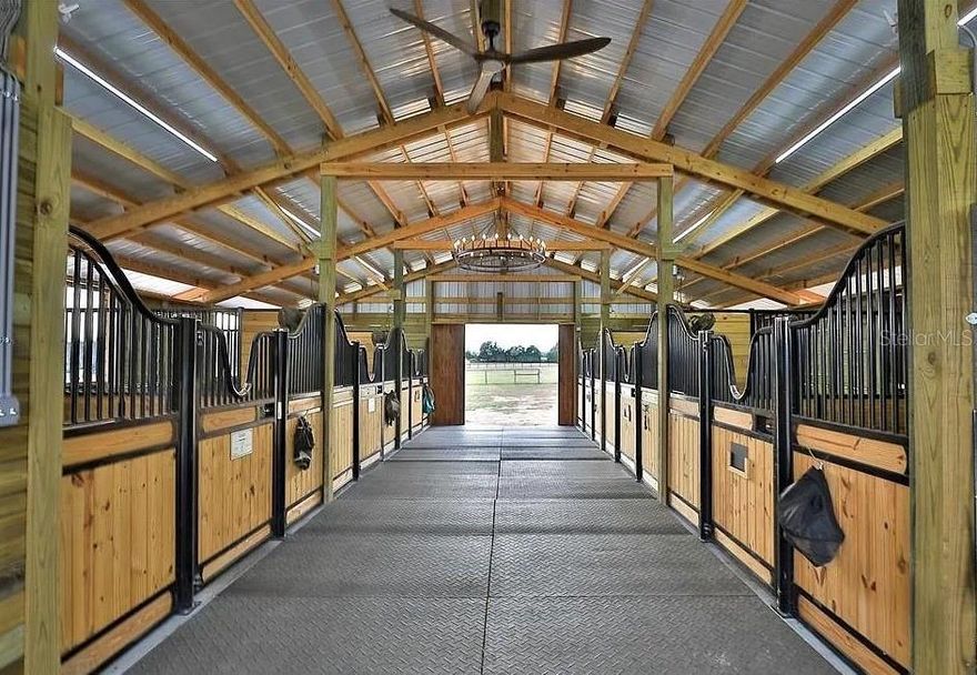 Where country living meets elite equestrian wellness — a truly one-of-a-kind horse property designed for performance, comfort, and care.
 
Nestled on 9.34 high-and-dry acres, this exceptional equestrian estate offers a rare combination of modern country living and state-of-the-art horse wellness amenities. Built in 2006, the beautifully maintained 3-bedroom, 2-bathroom single-story home features 2,372 sq ft of living space and blends comfort, functionality, and timeless style — all thoughtfully positioned within a fully equipped horse facility created with the animal’s well-being as the highest priority.
Inside the home, you’ll find an inviting open layout with cathedral ceilings, a cozy family room fireplace, and a seamless kitchen/family room combination ideal for everyday living and entertaining. The spacious Master Bedroom includes a walk-in closet. The roof was replaced in 2023, and the air-conditioning system was replaced in September 2024, offering peace of mind for years to come.
 
Step outside and discover what truly sets this property apart.
 
This farm has been meticulously designed as a premium equine wellness retreat, offering features rarely found anywhere else:
 
Equine Therapy & Wellness Facilities
• Climate-controlled full-body infrared therapy room featuring 7 adjustable wavelengths for targeted or full-body treatment
• Infrared panels can be removed, allowing the space to be converted into a climate-controlled tack room or grooming area
• Climate-controlled Himalayan salt therapy room, lined with authentic salt bricks to support respiratory health and skin condition
• Both wellness rooms are suitable for horses, dogs, and even human use
Professional Equestrian Infrastructure
• Barn with 6 Saratoga stalls, fans, grooming area, wash rack, and tack room
• hay storage barn
• Excellent barn ventilation for optimal airflow and horse comfort
• Integrated misting system to cool horses during hot Florida summers
• Additional barn with 2 stalls with dutch doors equipped with a misting system
• Riding arena for training and exercise
Thoughtful Horse-First Design
• Automatic waterers throughout pastures, dry lots, and barns
• Freeze-protected well, ensuring a reliable supply during colder weather
• Multiple pastures plus two spacious dry lots, ideal for horses requiring controlled grazing while still allowing freedom of movement
• Fenced grounds and carefully planned layout prioritizing safety and efficiency
With an attached 2-car garage, well and septic utilities, and expansive usable acreage, this high-and-dry property offers privacy, functionality, and endless possibilities.
Every detail of this estate was created for the horse. Whether you are a competitive rider seeking a training base or an owner caring for horses with special health needs, this extraordinary property delivers a level of equine comfort and innovation rarely available on the market.
A truly unique opportunity — properties like this simply do not exist twice.