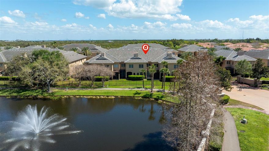 Welcome to Saxony Place, an exclusive gated enclave of townhomes in the heart of Carillon, St. Petersburg. This elegant and spacious residence lives like a single family home, offering nearly 3,000 square feet of beautifully designed living space with 3 bedrooms, 3.5 bathrooms, and a 2 car garage. Thoughtfully appointed with refined architectural details and generous room sizes, this home blends comfort, style, and low maintenance living in one of St. Petersburg’s most convenient locations. Professionally decorated and offered mostly furnished, the home presents a move in ready opportunity ideal for both full time residents and those seeking a refined lock and leave lifestyle.

A welcoming foyer entry sets the tone and leads to the formal dining room, beautifully accented with custom millwork, architectural columns, and display niches, creating an impressive space for entertaining and gatherings. The main living area is bright and inviting, centered around a fireplace that anchors the living room, while sliding glass doors open to a screened lanai overlooking a peaceful pond and fountain.

The chef’s kitchen is a true focal point of the home, featuring marble countertops, generous counter space, and abundant cabinetry designed for both everyday living and entertaining. Outfitted with stainless steel appliances, double wall ovens, a wine refrigerator, and an expansive walk in pantry, the kitchen combines style and functionality while providing plenty of space for meal preparation and entertaining.

Upstairs, all three bedrooms provide privacy and generous proportions, and each bedroom features its own ensuite bathroom. The primary suite is exceptionally spacious, complete with its own fireplace, two large walk in closets, and a separate sitting area that could easily function as a home office, lounge, or private retreat. The primary bathroom offers a spa like setting with dual sinks, a separate soaking tub, and a walk in shower, creating a relaxing space to unwind. A convenient upstairs laundry room with cabinetry adds everyday practicality right where it is needed most.

Additional highlights include plantation shutters throughout, paver driveway, tile roof replaced in 2022, and a spacious two car garage.

Built with solid block construction on both levels and hurricane rated windows and doors, this home provides exceptional durability and peace of mind. Notably, this community remained flood free during the 2024 storm season.

Located in Saxony Place, residents enjoy a beautifully maintained setting in the highly desirable Carillon area, with convenient access to dining, shopping, downtown St. Petersburg, Tampa, and both international airports.