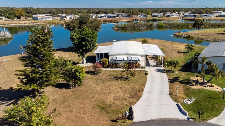 Welcome to one of the most picturesque Lakefront homes in Holiday Mobile Estates 3rd Addition.
This incredibly well-kept property combines comfort, lifestyle and an unbeatable location situated on an oversized lot on a Cul-de-sac with close to 104 feet of shoreline overlooking a couple of bird rookery's where Egrets, Blue Heron's and other water birds nest together.  It is a delight to watch them from the privacy of your own deck along with other wildlife.
Property highlights include spacious and inviting interior.  Large, open living room and formal dining room.  Light-filled Florida room Built to Codes in 2024 with different views of The Lake.  Perfect for peaceful mornings or afternoon relaxation.
Beautiful Dream kitchen featuring flat cooktop, a double oven, decorative tile backsplash, stainless steel appliances and more.  Breakfast Bar.
OTHER Upgrades for Peace of Mind include a New Covered Carport built to new Codes in 2024.  Lake-supplied irrigation system.  New gutters and electrical in 2022 with professional landscaping just done with outdoor lighting.  The Vapor Barrier under the home was replaced in 2022.  Freshly painted interior as well as the deck off of Primary Bedroom was recently stained.  Other updates were done as well.
You must see to fully appreciate this home and panoramic water views and glowing sunsets in your own backyard.

You own you property by Fee-Simple that offers long term stability.  Golf carts and Pets are welcome.
Holiday Mobile Estates 3rd addition is known for its warm, social and welcoming atmosphere.  
Continuing Membership to The Edgewater Clubhouse for $300 a year is optional along with the HOA for $35. annually.
The Clubhouse provides access to the Delightful swimming Pool, Tennis and Shuffleboard Courts, Bocce and Pickleboard Courts along with a Variety of Club activities for you to enjoy If you would like to.
This is an adult community with Deed Restrictions.
Mostly Sold Furnished/Turnkey.
This home is being Sold-As-Is, Subject to Buyer's Approval.
All Information here is deemed accurate and reliable, but Buyers/Buyer's agent should verify.