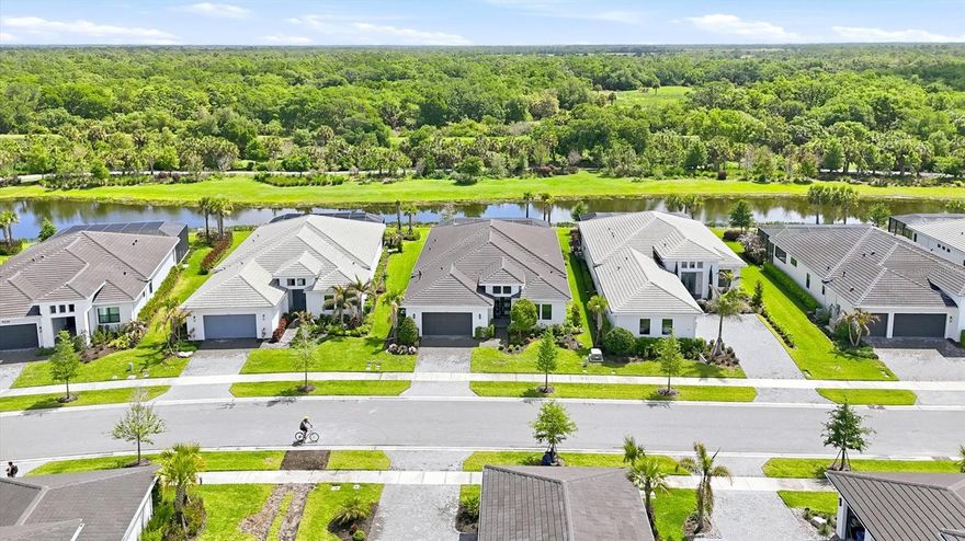 This highly sought-after 3 bedroom + Den and 3 bath model in Artistry Sarasota offers the perfect blend of luxury, privacy, and opportunity—ideal for buyers seeking a refined Sarasota lifestyle with the ability to personalize and elevate the home to their own taste. Perfectly positioned on a tranquil lake with peaceful views of the community nature trail beyond, this property delivers a rare sense of serenity and privacy while remaining just 10 miles from downtown Sarasota.
Designed for seamless indoor-outdoor living, the open-concept floor plan features two expansive sliding glass doors that lead to a private outdoor retreat complete with a saltwater pool and spa. The lanai is already equipped with gas, water, and electric connections for a future outdoor kitchen, creating the perfect foundation for a custom entertaining space tailored to your lifestyle.
Inside, the bright and airy kitchen features quartz, countertops, waterfall counter tops on the island, custom cabinetry, under-sink water filtration, and generous gathering spaces designed for both everyday living and entertaining. A whole-home water softener adds additional comfort and convenience. The spacious primary suite is filled with natural light from elegant bay windows and features a spa-inspired bath with an oversized walk-in shower. A flexible den offers space for a home office, media room, fitness studio, or additional guest accommodations.
Luxury buyers will appreciate the strong architectural foundation, premium homesite, and exceptional location—offering the ability to enhance and curate the interiors over time while already enjoying the best of Florida living today.
Residents of Artistry Sarasota enjoy maintenance-free living and resort-style amenities including a community pool, pickleball courts, basketball courts, playground, and scenic walking trails. Located approximately 10 miles from downtown Sarasota, this home offers convenient access to world-class dining, shopping, arts, golf, and Gulf Coast beaches while maintaining a peaceful residential setting.