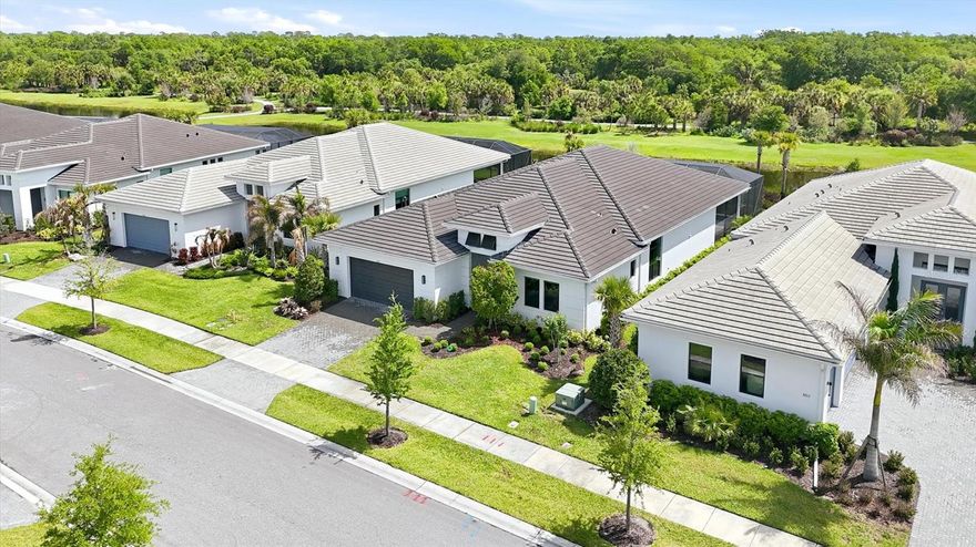 This sought-after Van Gogh model is designed for effortless Florida living, featuring an open-concept layout and two expansive sliding glass doors that seamlessly connect indoor and outdoor spaces. Step outside to your private oasis—a saltwater pool and spa overlooking a tranquil lake, with peaceful views of the community’s nature trail and lake creating a serene, private backdrop rarely found this close to everything Sarasota has to offer. The lanai is prepped for your dream outdoor kitchen, with existing gas, water, and electric hookups already in place, making it easy to customize the space to suit your lifestyle and entertaining needs. Inside, the home is both elegant and functional. The bright white kitchen showcases quartz countertops, custom cabinetry, an under-sink water filtration system, and an open floor plan that flows beautifully into the main living areas. Enhancing comfort and quality throughout the entire home, a water softener has also been installed. The spacious primary suite is enhanced by bay windows that fill the room with natural light, along with a spa-like bathroom featuring an oversized walk-in shower. A versatile den/flex room offers the flexibility today’s buyers need for a home office, playroom, or guest space. The laundry room has been thoughtfully upgraded with custom cabinetry for added convenience and storage. Located within Artistry Sarasota, residents enjoy maintenance-free living and access to resort-style amenities including a community pool, playground, basketball, and pickleball courts. This prime location places you just minutes from shopping, dining, and everyday conveniences, while still offering a peaceful, tucked-away feel. Downtown Sarasota is only about 10 miles away, giving you easy access to world-class restaurants, arts, and beaches. This is the ideal home for luxury buyers seeking a quiet, refined lifestyle without sacrificing proximity to everything Sarasota has to offer. Flood Zone X.