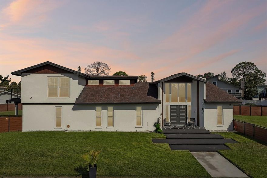 Welcome to 5201 Huntington Street NE — a rare opportunity in the highly sought-after Shore Acres neighborhood of St. Petersburg. Situated on nearly half an acre, this oversized corner-lot property delivers the kind of space, privacy, and curb appeal that is almost impossible to find in this area. Completely remodeled with a sleek Miami-chic modern design, this stunning residence blends luxury finishes with functional everyday living.

Offering over 3,300 square feet, the home features 3 spacious bedrooms, 4 full bathrooms, vaulted ceilings, two large living areas, a formal dining room, and an abundance of natural light throughout. The open and airy floor plan creates an inviting atmosphere perfect for both entertaining and relaxing. Recent upgrades include a 2024 roof, luxury vinyl flooring, impact-rated hurricane windows, and updated systems that provide both style and peace of mind. Upstairs, a spacious loft area and private outdoor patio deck overlook the sparkling pool and expansive backyard retreat. The fenced backyard offers endless possibilities with ample room for entertaining, pets, outdoor activities, or future additions. Whether hosting guests or enjoying a quiet evening at home, this property was designed to embrace the Florida lifestyle. Located just minutes from vibrant Downtown St. Petersburg, waterfront parks, shopping, dining, and approximately 30 minutes to the Gulf beaches, this home offers the perfect balance of convenience and peaceful neighborhood living. Opportunities to own a move-in-ready property of this caliber on nearly half an acre in Shore Acres are exceptionally rare. Schedule your private showing today.