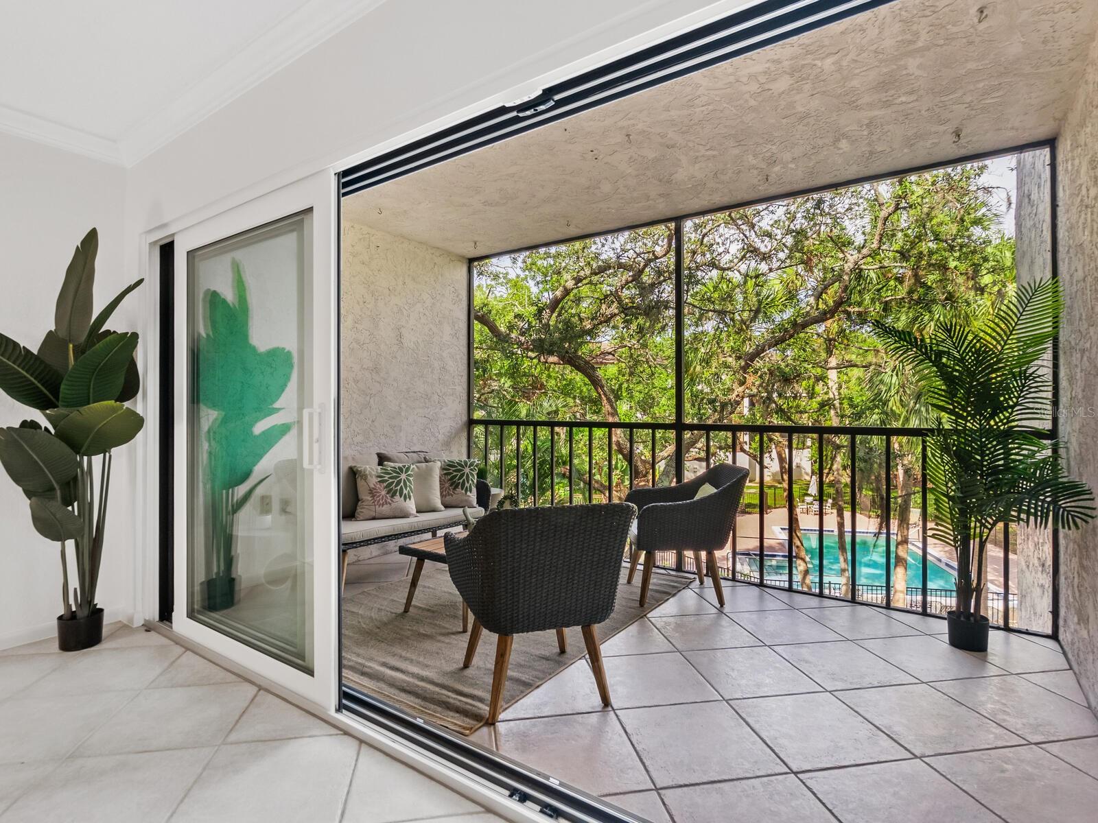 Seller is offering owner financing with favorable terms! Welcome to your slice of Old Florida charm in the heart of the city. This beautifully updated two-bedroom, two-bath condominium offers comfort, style and convenience in a lush, park-like setting. Enter to new carpet and freshly painted interiors, complemented by high-end finishes including solid wood cabinets, crown molding and a custom built-in bar ideal for entertaining. Enjoy peace of mind with hurricane-impact windows installed in 2023, backed by a transferable lifetime warranty. The guest bath has been fully remodeled with elegant Restoration Hardware finishes, and a new washer and dryer (2023) add everyday convenience. Take in serene views of the pool and Philippi Creek from the spacious living room and both bedrooms or relax on the large screened lanai surrounded by mature landscaping. This condominium is in a vibrant pet-friendly community featuring a five-acre park along Philippi Creek, a clubhouse with active social calendar, and a pedestrian bridge to Tuttle Bee Plaza for easy shopping and dining. Just minutes from white sands of Siesta Key (under five miles) and the arts and culture of downtown Sarasota (less than four miles), this centrally located oasis is a rare find. Don't miss your chance to own a move-in-ready gem in one of Sarasota’s charming communities.