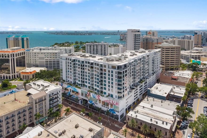 Rare penthouse offering at Mark Sarasota. 111 S Pineapple Ave. #1204 is a one-of-a-kind 12th-floor residence and the largest home in the building, offering 2,845 square feet under air and over 3,600 square feet of total living space including a spacious wraparound covered terrace with uninterrupted views of Sarasota Bay. From the moment you go inside, you’re greeted by 11-foot ceilings, double 8-foot entry doors, and expansive 10-foot impact-rated sliding glass doors that blur the line between indoors and out. Gleaming 24-inch white polished porcelain tile floors run throughout the open-concept interior, where a thoughtfully designed layout integrates the living, dining, and family spaces with a chef-caliber kitchen—complete with high-gloss European cabinetry, quartz countertops, and a suite of premium Jenn-Air stainless steel appliances including a 42-inch built-in refrigerator, convection wall oven, and 36-inch induction cooktop. The primary suite is a private oasis, offering panoramic views, dual walk-in closets by California Closets, and a spa-inspired en-suite bath with double vanities, an oversized walk-in shower, deep soaking tub and sleek Grohe fixtures. Two generous guest suites, each with private baths, custom closets and blackout shades, provide comfort and privacy for visitors or family. Additional interior highlights include a convenient and spacious family room/den, automated roller shades throughout with blackout shades in all bedrooms, a full laundry room with custom cabinetry and Whirlpool HE washer and dryer, water filtration and softener systems for the entire residence, and four deeded garage parking spaces plus a same-floor oversized private storage unit. The wraparound covered terrace is an entertainer’s dream with commanding views of the water and city skyline. Enjoy alfresco dining at the built-in outdoor kitchen, equipped with an electric grill, under-counter refrigerator, stone countertops, and durable exterior cabinetry. Residents of The Mark enjoy exceptional lifestyle amenities including 24-hour concierge service, a resort-style heated saltwater pool and spa, state-of-the-art fitness center with a dedicated spin room, a club room with catering kitchen, fireplace and billiards, as well as outdoor lounging areas with fire pits, grills, and dining spaces—all just steps from Whole Foods, Bayfront Park, shopping, dining, galleries and Sarasota’s renowned cultural venues. This rare penthouse opportunity places you in the heart of downtown Sarasota’s most desirable address, where convenience, comfort and coastal elegance converge.