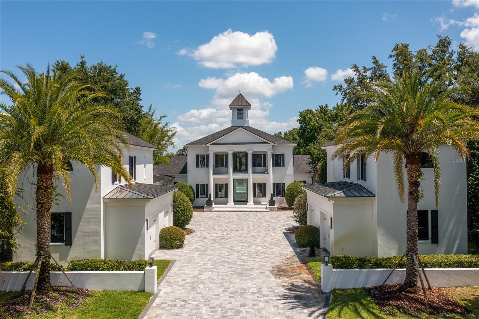 One of the finest offerings on The Butler Chain of Lakes! A true beauty on 2+ privately gated, magnificent grounds with awesome views over Pocket Lake. Updated with custom features too numerous to mention. This fine property was carefully designed and features a new roof. Two separate carriage houses each with 2-car garages (one has a convertible gym) have upper living areas both with a bedroom, full bath, kitchenette and living area - pleasing to care-taker, extended guest, home offices or whatever the need. - Spacious master suite on lower level with spacious bathroom and walk-in closet with access to the office - also, formal LR, DR, FR and designer kitchen which includes another large family eating area with superb views of the pool and lake. Complete upper level SUITES with common loft area, opening to balcony. One bedroom is currently a golf simulator room. Just a few of the fine features include a RO water system - over-sized pool with low maintenance salt water system, summer Kitchen with 1/2 bath and shower, cabana with fireplace, sitting area with fire pit, and of course the covered lanai and boat dock with boat and jet ski lifts.