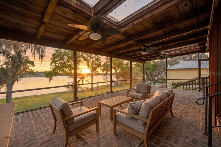 One or more photo(s) has been virtually staged. STUNNING SUNSETS every evening, and an exceptional opportunity to own over half an acre of direct lakefront on the sparkling shores of East Crooked Lake—a private, fresh water, spring-fed ski lake, known for its pristine, white sandy bottom and crystal-clear waters. Boasting over 100 feet of true lake frontage with no roads in between, this property offers the ultimate waterfront lifestyle with your own private dock for boating, wakeboarding, paddle-boarding, waterskiing, or simply unwinding under the Florida sun. Tucked away in one of Central Florida’s most desirable locations, you’re just minutes from the charm of downtown Mount Dora, filled with boutique shopping, dining, and year-round festivals. The home is thoughtfully positioned to capture breathtaking lake views the moment you walk in, with sliding glass doors that open to a spacious 30x16 screened lanai—perfect for taking in the sunset each evening. With a versatile tri-level layout offering multiple living spaces, a private primary suite, and additional room for entertaining or guests, this well-loved, custom built, one-owner, property presents endless potential to create your dream lakefront retreat, full-time residence, or investment in a truly special setting.