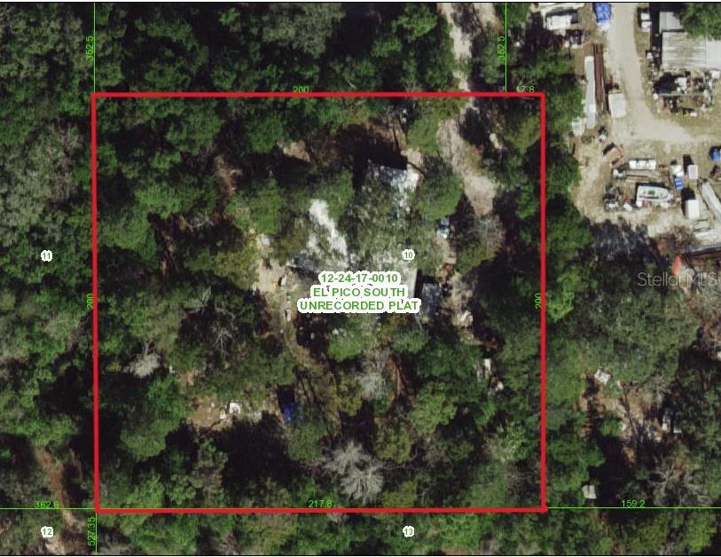 1 Acre lot with RV power source. The small RV is included! There is a residence on this lot ready for demolition. Well, Septic, and power pole on premises. The power to the residence has been disconnected for demolition.