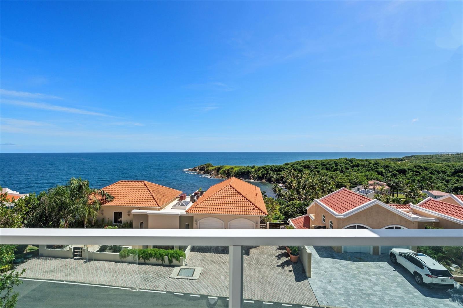 One or more photo(s) has been virtually staged. There’s a difference between waking up in Palmas del Mar and waking up above it. At Shell Castle Club #74, the ocean greets you from every level, an ever-changing horizon of blues that becomes part of your daily rhythm.
This completely reimagined 3-bedroom, 2.5-bath townhouse spans approximately 2,600 square feet of living space that blends design, technology, and comfort. Sunlight pours through wide glass doors revealing panoramic views of the Caribbean Sea and the lush hills of the resort. Every finish feels intentional, from the modern open kitchen to the sleek bathrooms and seamless indoor-outdoor transitions.
Equipped with a 2-car enclosed garage, power generator, electric storm shutters, and motorized window shades, this home offers beauty with peace of mind. The multiple terraces invite coffee at sunrise and wine at sunset, making every day a vacation you never have to leave.
Palmas del Mar isn’t just a location; it’s a lifestyle. Enjoy two championship golf courses, a tennis and pickleball center, an equestrian club, beach club, marina, restaurants, and miles of golf-cart trails. Families love being moments away from The Palmas Academy, a top English-language college-prep school that makes living here effortless year-round.
Shell Castle Club #74 isn’t just a home; it’s a front-row seat to the best life the Caribbean has to offer.