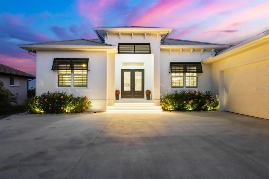 Perfectly positioned on a prime golf course front homesite with breathtaking lake and fairway views, this 2025-built luxury residence showcases awe-inspiring design and uncompromising construction quality. Offering 3 bedrooms plus a spacious den/family room, 3 full baths, and nearly 3,000 square feet under air (approximately 4,700 total square feet), this exceptional home blends elegance, comfort, and superior craftsmanship.  A grand double-door entry opens to a dramatic foyer with instant, mesmerizing views of the golf course, lake, and spectacular pool lanai. Expansive living areas are enhanced by soaring 12+ foot ceilings, large-pattern plank tile flooring throughout, and premium designer finishes at every turn.  The impeccably appointed kitchen is a true showpiece, featuring stunning Taz Mahal stone countertops, an oversized island wrapped in additional cabinetry, designer tile backsplash, built-in stainless steel appliances, and a generous butler's pantry. The adjoining great room impresses with a towering tray ceiling and a striking large marble feature wall with grand inlay fireplace.  A spacious den/family room offers secluded comfort with direct pool access and tranquil views - perfect for relaxing or entertaining. Bathrooms boast exquisite tile work, complemented by premium lighting and plumbing fixtures throughout the home. A bright, oversized laundry room just off the butler's pantry provides abundant storage and workspace.  Outdoor living is nothing short of sensational. The heated pool and spa are surrounded by an immense covered lanai, an open-air sitting area with fire pit, and beautiful stone pavers - creating the ultimate setting for quiet evenings or vibrant gatherings.  Additional highlights include a metal roof, impact-resistant windows and sliders, a grand circular driveway, and a three-car garage with epoxy-coated flooring and a convenient lift system to the spacious attic.  Ideally located in a superb coastal setting just minutes from three marinas, the pristine sandy beaches of Palm Island and Boca Grande, world-class fishing and boating, outstanding private and public golf courses, and within golf cart distance to essential shopping and dining.