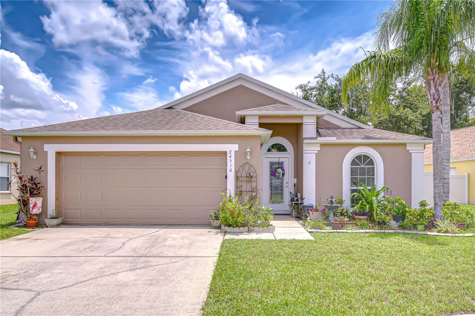 Located in the desirable Oak Grove community in Lutz, this move-in-ready single-story 4-bedroom, 2-bath home with a den/flex space has everything you’re looking for -- including a recently added pool in 2021! The well-designed 3-way split floor plan offers over 1,800 sf of comfortable and functional living space, along with a 2-car garage. A quaint covered front porch leads into an inviting foyer adjacent to a light-filled room ideal for an office or additional sitting area. The cozy and spacious eat-in kitchen features a large window, recessed lighting, ample cabinetry, new stainless steel fridge, pantry closet, and a large breakfast bar pass-through, great for entertaining. The expansive living area is enhanced by a vaulted ceiling and has ample room for a formal dining setup. All dual-pane windows were updated in 2018, including the glass slider, which leads out to a beautiful screen-enclosed pool area featuring a pavered deck and a charming covered patio, creating an ideal outdoor retreat just steps from your living room. The saltwater, free-form pool was just added in 2021 and is a must-have for the ideal Florida lifestyle. The vinyl-fenced backyard adds privacy and is complete with gates on both sides, including a double-gate for added convenience. Back inside you will find a generous primary suite featuring vaulted ceilings, a walk-in closet, and en-suite bathroom with dual sinks, garden tub, separate shower, and private pool access. Two secondary bedrooms on the opposite side of the home share a newly updated guest bathroom, while the fourth bedroom is nicely tucked away on its own -- offering added privacy for the whole family. Oak Grove is an established community with NO CDDs, low HOA fee, conveniently located within walking distance to Denham Oaks Elementary School and an easy drive to a plethora of nearby conveniences, including multiple grocery store options, Costco, the Tampa Premium Outlets, Wire Grass Mall, fantastic restaurants, and convenient access to SR-54 and I-75 just minutes away.