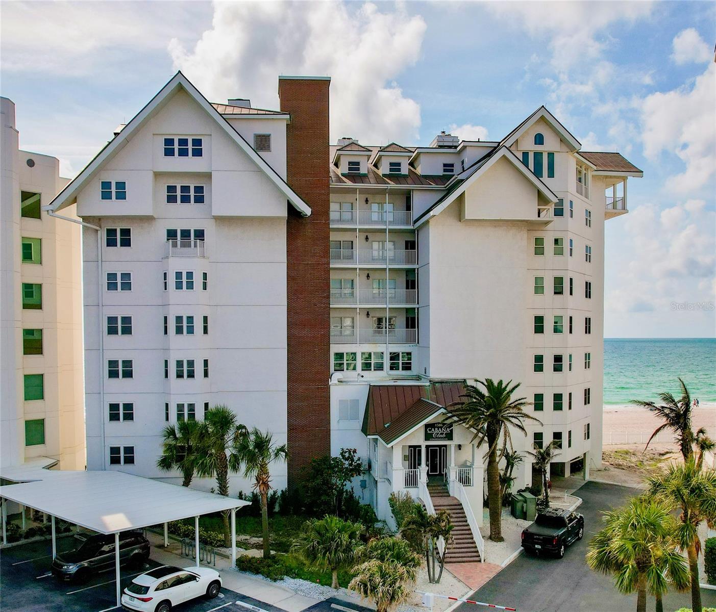 Welcome to Cabana Club on Sand Key. This is your opportunity to enjoy a little slice of paradise. This recently updated 5th floor condominium offers unparalleled views of the silky sand beach and sparkling waters of the Gulf. You will enjoy the year round unobstructed sunsets that you can sit and enjoy from the serenity of your spacious private balcony. This unit has been update with new engineered hardwood flooring throughout, and 7 inch baseboards. Bathrooms are appointed with new porcelain tile, quartz counters, sinks and fixtures. Main living areas have been enhanced with crown moldings to add an additional touch of style, and updated paint throughout that gives a light spacious feeling to the rooms. Kitchen features new quartz counters, sink and fixtures and allows for easy conversations with guests at the bar. There is also a den/office space at the front of the unit that can work as a third bedroom. Wide opens from the sliding doors allow for a seamless flow from the living space to the outdoors, where you can enjoy the endless vista of the Gulf and the sunsets yet to come. Balcony features recently updated rails, and ceramic tile flooring as well as a new outer storm shutter for the balcony. For added security and peace of mind there is also inner shutters for the patio doors from the primary bedroom and the living room. The HVAC was updated in 2019, the hot water heater is an electric on demand system that was installed in 2019. The primary suite features storm rated windows, and access to the balcony, as well as ensuite bathroom with separate tub and shower as well as dual sink vanity and lots of storage including a separate linen closet. Cabana Club offers resort-style amenities including a gulf-front fitness center, heated salt water pool, basketball, pickleball and shuffleboard courts steps from your door. Tennis courts are available across the street in Bay Park. The park also offers a playground and picnic tables. This unit features assigned (#21) under-building parking as well as storage space for beach equipment on main level under the building. With easy accessibility to shopping, entertainment, medical and airports and turnkey convenience and panoramic gulf views, this beachfront oasis offers the ultimate Florida lifestyle. This is an amazing opportunity to make this dream home your reality, make an appointment soon!