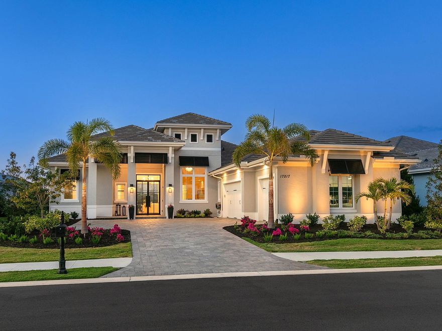 Stunningly upgraded in the Lake Club is this Chandler IV floor plan by Stock Luxury Homes. This home has had a meticulous makeover throughout 2024 that is sure to please the most discerning buyers.  The elegant floor plan even has a highly desirable private detached casita!  Recently built in 2023, the current owners have overhauled the entire look of the home to evoke modern living with functional and luxurious spaces.  This lot enjoys the best of both worlds with a stunning lake view from the front, and a conservation preserve view from the northern rear exposure.  Amidst upgraded, blooming landscaping you’ll be welcomed home through a brand new 2025 impact glass door that features remote-controlled privacy glass that changes from clear to obscure at the click of a button.  The open floor plan is complemented by all new 2024 engineered hardwood flooring and designer light fixtures.  The central great room is the perfect place to gather with extra high tray ceilings and pocketing impact sliding glass doors.  The chef will appreciate luxurious kitchen upgrades including new 2024 high-end Fisher & Paykel dual dishwasher drawers, Bosch French-door refrigerator, and Hisense wine refrigerator added to the island.  The kitchen exudes a refined modern style with crisp white cabinetry, sophisticated gray island cabinetry, marble backsplash, quartz counters, colossal island with wrapping counter height seating, a dry bar prep area, and walk-in pantry with plentiful shelving.  The adjacent dining room takes advantage of the proximity to the outdoor kitchen through pocketing impact sliding glass doors for seamless entertaining.  The oversized paver lanai is poised for sunny afternoons spent cooling off in the pool and spa, or for cozy evenings under the stars taking in the preserve views.  This outdoor oasis includes motorized shades on the screen enclosure that can withstand 70MPH winds, so every day is your very own private and protected paradise.  The pool also features water bowls, sun shelf, and an impressive 37’ long lap pool ideal for swimming.  The extensive outdoor kitchen with island, granite counters, 2024 stainless steel Blaze grill and beverage refrigerator.  The backyard has a 2024 fence perfect for furry friends, 2024 LED landscape lighting, and 2024 French drains for improved water drainage.  Inside your private Owners Suite you’ll find respite with a spacious bedroom with tray ceiling, French doors to the lanai, and dual walk-in closets.  The en-suite bath features an oversized walk-in shower, freestanding soaking tub, and dual vanities.  Guests will have their selection of 4 guest bedrooms all elegantly equipped with private en-suite bathrooms and walk-in showers.  The rear bedroom is also functional as a bonus room with disappearing corner impact sliders to the lanai.  And don’t forget about the multi-use Casita with its own private entrance, en-suite bathroom, and pre-plumbed for a future kitchenette.  The private study includes high ceilings and double doors for increased privacy.  Your 3-car side-loading garage has plenty of space for vehicles and toys, plus added 2024 storage solutions.  Peace of mind is secured with impact windows and sliders, 2024 security cameras, 2024 HALO water filtration system, 2024 DAB water booster system, and 2024 instant hot water pump.  The Lake Club is an exclusive premier, gated community with a Grande Clubhouse, restaurant, pool, tennis, pickleball and more.