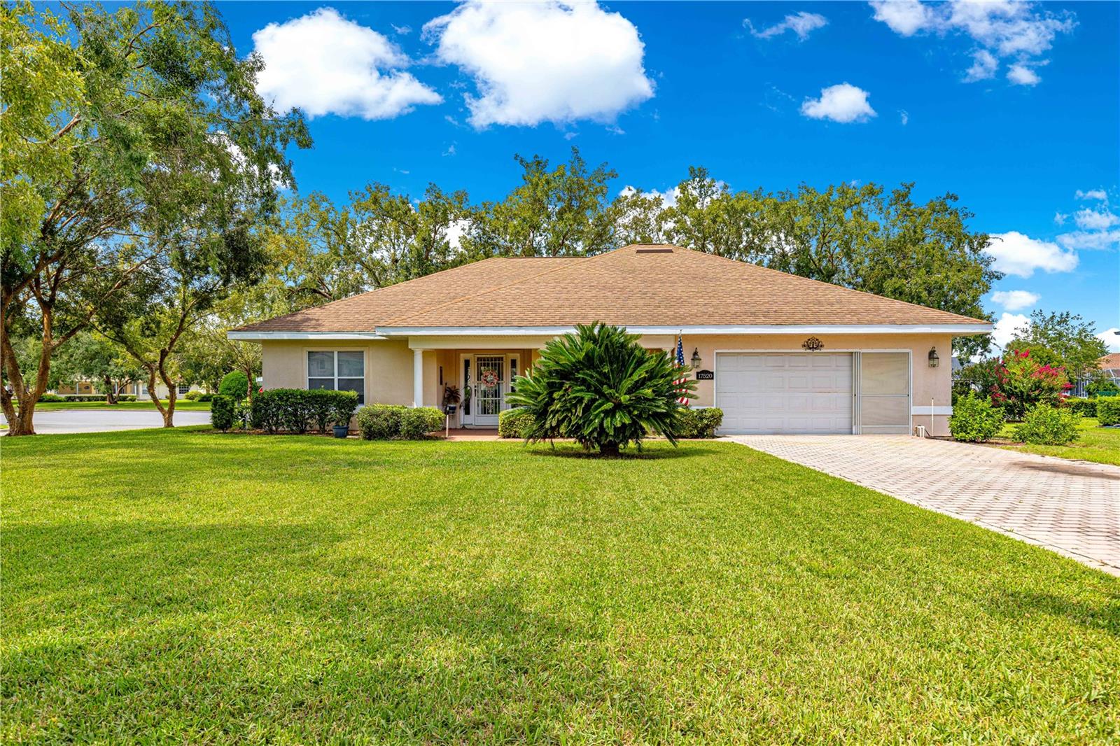 Welcome to this lovely 2 bedroom 2 bathroom beautiful home in Stonecrest. As you drive up to this home you will notice the well manicured lawn with mature trimmed landscaping on a Extra large corner lot that is very level and well taken care of. The paver driveway leads you up to the two car garage with screens to let the breeze flow all thru the home. As you enter the home you will notice the open concept that is a great floorplan for entertaining guests. It would be very easy to make two master suites with this floor plan, but you will also be able to have one master and one guest room. Your friends will meet in the middle of this home to spend hours telling old stories in the central dining room that is the focal point of entertaining. The large kitchen has great counter space for rolling out the dough when making your grandma's favorite dish. You can really forget the troubles of the day while sipping a glass of wine on your enclosed lanai that is shaded by the mature trees. Your added inside laundry is a nice feature and a little extra storage space. The Garage is a full two car wide which means the driveway is wide enough to accommodate two cars the whole length. A/C was replaced in 2024 Roof was replaced in 2004. This home is ready for it's next owner Call today for a private showing.
