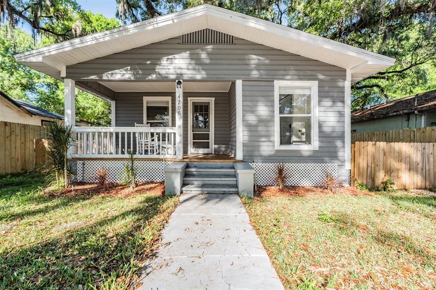 Welcome to this charming and beautifully updated 3 bedroom, 2 bathroom alley access bungalow, nestled in the heart of Seminole Heights, one of Tampa’s most sought after historic neighborhoods. This inviting home blends classic character with modern upgrades, making it perfect as a primary residence, vacation home, or income-producing property. Step inside from the covered front porch to discover a cozy living room and fully remodeled eat in kitchen featuring elegant quartz countertops, newer cabinetry, and sleek stainless steel appliances, ideal for both everyday living and entertaining. The open layout is complemented by newer waterproof luxury vinyl flooring that flows seamlessly throughout the home, adding durability and style. The spacious primary bedroom suite offers a private retreat with a fully updated en suite bathroom, while both bathrooms have been tastefully remodeled with contemporary finishes. Major updates include a newer HVAC system, roof, and vinyl siding, providing peace of mind for years to come. Located just minutes from Tampa’s Riverwalk, downtown Tampa, Ybor City, and Tampa International Airport, and a short drive to the St Pete beaches, you’ll enjoy unbeatable access to dining, entertainment, and travel. Currently operating as a successful short term rental with $2,900 average monthly income, this home presents an excellent investment opportunity (earnings report available upon request). Furnishings are optional, allowing for a turnkey experience if desired. Priced below market value, and not located in a flood zone, this is a rare opportunity to own a move in ready home in a prime location. Don’t miss your chance to make it yours. Call to schedule your private showing today!