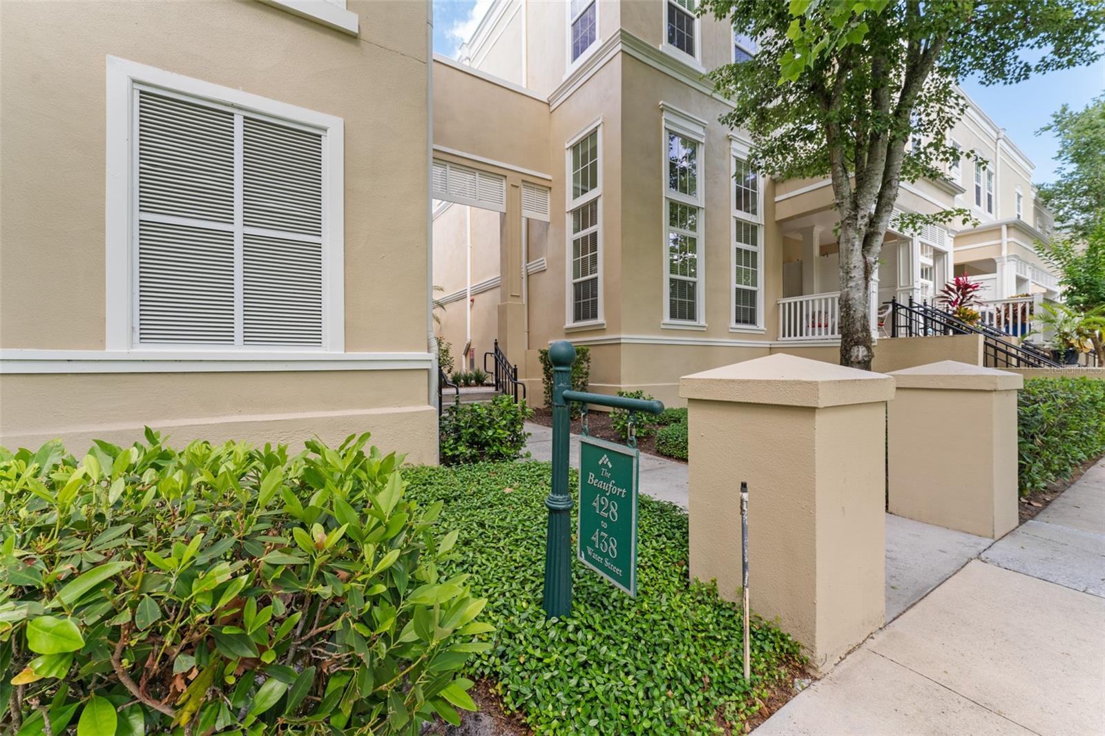 Welcome to your dream condo in Celebration, Florida—a thoughtfully updated two-bedroom, two-bath condo situated on the highly desirable Water Street, where scenic beauty meets vibrant community living. Tucked alongside a peaceful canal and framed by lush landscaping and charming architecture, this residence offers the kind of setting that feels like a retreat, yet keeps you connected to everything that makes Celebration special. As you enter, you’re greeted by a spacious, open-concept layout that feels bright, airy, and inviting. The combined living and dining areas are oversized, offering plenty of room for both casual lounging and entertaining guests. Crown molding adds a touch of elegance, while plantation shutters allow for both natural light and privacy. The large windows perfectly frame serene views of a manicured green space and a mature, graceful live oak tree—creating a backdrop that feels calming and picturesque. The kitchen is a standout feature, completely renovated with today’s homeowner in mind. You’ll find fresh white cabinetry offering abundant storage, a sleek tile backsplash that adds texture and warmth, and stainless steel appliances that give the space a modern edge. The under-mount stainless steel sink is as functional as it is stylish—ideal for prepping meals or simply enjoying a morning coffee while watching the light filter in. The owner’s suite is spacious and tranquil, offering a true place to unwind. From the detailed molding to the walk-in closet and generous layout, this bedroom checks every box. Large windows offer more beautiful views of the green space, so you’ll wake up every morning feeling relaxed and connected to nature. The en-suite bathroom provides both privacy and convenience. The second bedroom is also generously sized, making it perfect for guests, a home office, or even a creative studio space. It has easy access to the second full bathroom, which is ideal for functionality and flow. Step outside and the real magic of this location continues. Water Street is one of Celebration’s most charming and walkable areas, with lovely sidewalks lining a scenic canal. A short stroll brings you right into downtown Celebration, where brick-lined streets lead to locally loved restaurants, charming cafes, wine bars, boutique shops, and seasonal events. The Sunday farmers market is a local favorite, offering fresh produce, handmade goods, and a wonderful sense of community. For golf lovers, the Celebration Golf Course is just steps away, offering beautifully designed greens surrounded by natural Florida beauty. Whether you’re an avid player or just enjoy the occasional round, having this course practically in your backyard is a major bonus. Celebration is more than a town—it’s a lifestyle. With its front-porch charm, vibrant community events, miles of walking and biking trails, and friendly neighborhood feel, this is the kind of place that people fall in love with. And this condo, with its perfect blend of style, location, and comfort, gives you a front-row seat to it all. Whether you’re looking for a full-time residence, a seasonal getaway, or a low-maintenance second home in one of Central Florida’s most sought-after communities, this Water Street condo delivers on every level.