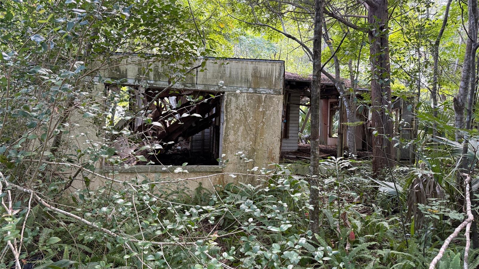The existing structure holds no value and will need to be completely demolished. The existing structure is not safe to access—PLEASE DO NOT ENTER. The true worth lies in the land, offering endless potential for a savvy investor or builder. The property line begins right at the trees, with the driveway marking where the property starts. while the tree line may look like it sits far inside, it is actually the true boundary of the house line. Don’t miss this opportunity—schedule your showing today!