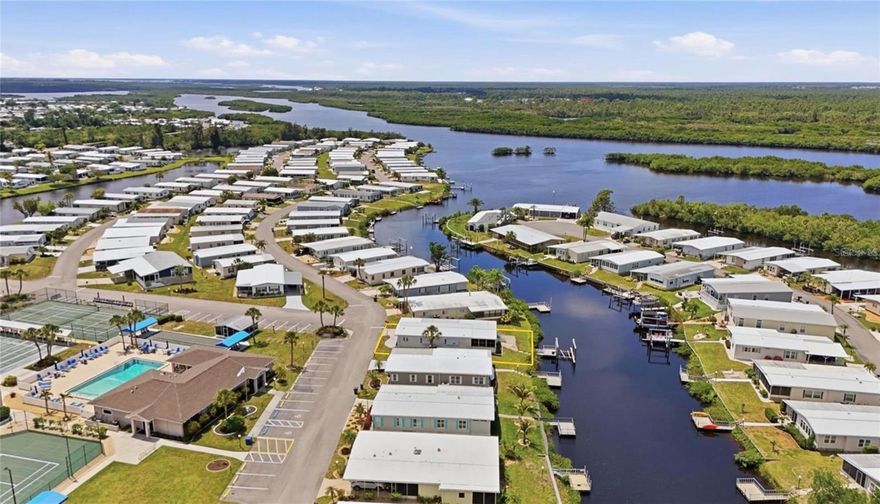 Welcome to Lazy River Village! One of the premiere (if not THE best) 55+ waterfront manufactured park in all of Sarasota and Charlotte counties! The BEST amenities, clubs, and selection of activities you will find in any co-op park in all of Sarasota county and even Charlotte County. Lazy River is located on the banks of the beautiful Myakka River. 

This 2 bed 2 bath waterfront home is ready for a new owner to make this their special get-a-away.  NEW Metal Roof/ NEWER A/C unit, NEWER Windows! This waterfront home offers a great water view and comes with a boat lift and dock! The Myakka River is 1 minute from your canal dock. The home features an open floor plan with plenty of room to entertain. This home is the perfect seasonal place to enjoy Florida's coveted gorgeous winters and a perfect year-round home for those who love all 4 seasons of Florida. If you enjoy an abundance of activities, you will have plenty to choose from in Lazy River Village: Pickleball, tennis, bike clubs, card clubs, and pontoon boating. They even have a professional woodworking shop. A low monthly fee of $276 includes all the amenities. There are other amenities for an extra fee, such as a marina slip if your home is not located on the water. 

One of the things that makes Lazy River Village so great is its proximity to...well...everything! Be prepared to enjoy Florida's wildlife at its finest, both inside the Lazy River Village complex and at abundant state parks and nature preserves. Shopping and dining surround you in all directions. The spring training homes of both the Atlanta Braves & the Tampa Bay Rays are just a minutes away. The world-renowned Gulf of Mexico beaches are all within 30 minutes or less! 1) Englewood beach, 2) Casperson Beach (GREAT for shelling), 3) Venice Beach (shark tooth capital of the world), 4) Brohard Paw Park, 5) Nokomis beach (you've GOT to experience the weekly drum circles), 6) the island gem of southwest Florida: Boca Grande... And finally: 7) Siesta Key in Sarasota has been ranked multiple times as the number one beach in the nation and is a mere 35 minutes away. Lazy River Village offers a lifestyle that every retiree dreams of. You have the quaint downtowns of Venice and Punta Gorda--both cities are often ranked as Top 10 destinations in the country for retirement. Another local favorite, Englewood, is a cozy, fun beach town on the Gulf of Mexico. 

The residents of Lazy River Village agree: Lazy River is a community that offers it all. Don't miss your chance to see this home!