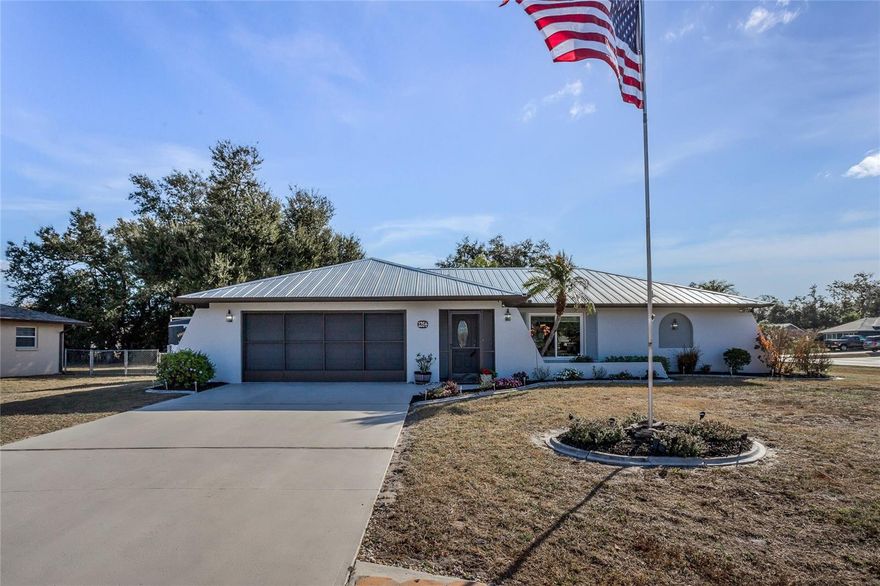 Welcome to your dream home! This beautiful 2-bedroom, 2-bathroom home is a true gem. Step inside to discover a tastefully remodeled kitchen and bathrooms, granite counter top, and breakfast bar for informal eating. The master bedroom has a walk-in closet with extra shelving. The interior and exterior of this home has been freshly painted in neutral colors with new luxury vinyl flooring throughout. Enjoy peace of mind with a 2022 metal roof, providing durability and contemporary style. Updated 80 gal water heater, A/C installed 2020, Impact windows installed in 2020 (excluding sliders), flood the interior with natural light, creating a warm and inviting atmosphere. Sliders take you to large Florida room complete with vinyl windows & screens. This home is located on an oversized corner lot with a 10 x 12 shed with loft for extra storage, patio pavers and boasts a fire pit with room for a future pool making this home ideal for entertaining. The 2 car garage floor has been recently finished with Epoxy. Home is located in a great neighborhood. Don’t miss this opportunity to make this your home sweet home!