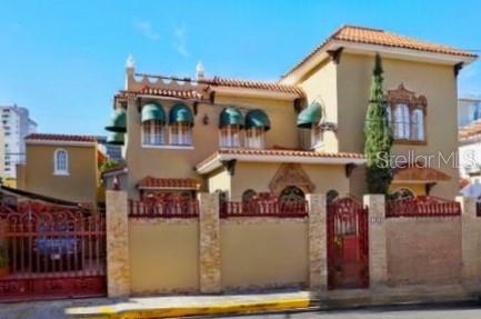 Architectural gem for sale in Condado could be yours!This Spanish Colonial Revival-style house features an impressive façade adorned with a wrought iron fence embellished with 'Flor de Lis' details, terracotta roof tiles, and arched stained glass windows. Upon entering the foyer, you'll be impressed by the high ceilings, hanging chandelier, terrazzo floors, and the stunning wrought iron staircase leading to the second level. The two story home of 3,557 square-foot sits on a lot of 397.75 square-meter and includes on the first floor the balcony, living room, dining room, family room, kitchen, breakfast table, a wet bar ideal for entertaining and a full bathroom. On the second level, there are 4 spacious bedrooms with 3 bathrooms. The house features an automatic 65 KLV power plant, a 60-gallon water cistern, a two-car garage, and a maid's room with its own bathroom. Its enviable location is steps away from renowned schools such as St. John's and Robinson, supermarkets, restaurants, hotels, Antonia Quiñones Park “Parque De Condado”, Ashford Presbyterian Hospital, and a short drive from the airport. Don't miss this rare opportunity to live in this elegant Spanish Colonial Revival-style home.