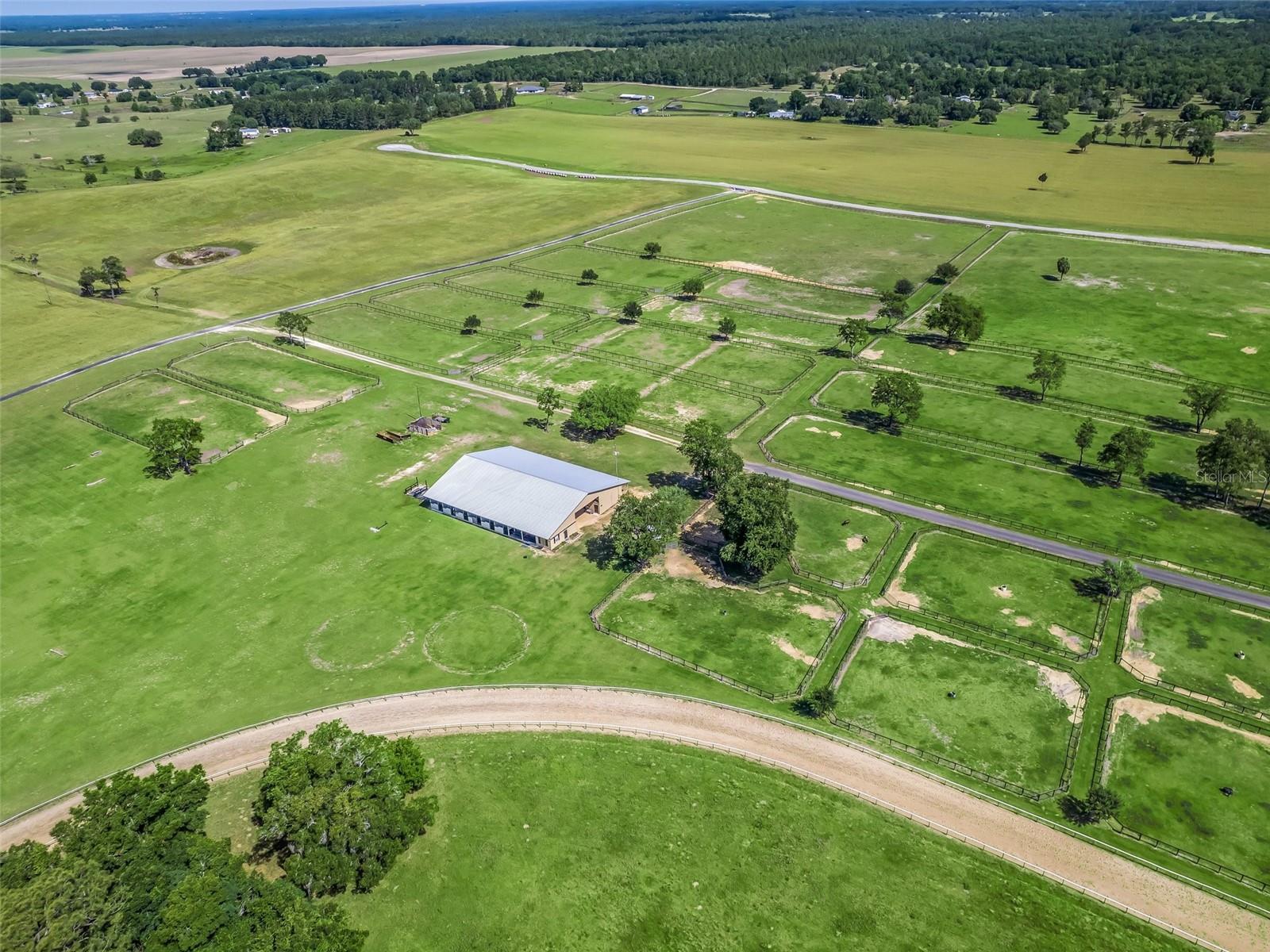 Spectacular farm for rent only 10 minutes from the World Equestrian Center and 15-minutes from HITS. This beautiful farm includes a large 29 stall barn with 12 grass pastures, 2 wash racks, RV hookups, a tack room, feed room, bathroom and grooming area. All stalls are 12x12 with plenty of air flow. The farm provides ample space for riding and training, with expansive grass areas suitable for setting up show jumps and dressage arenas. An ideal setting for event riders with cross-country jumps and a water hazard already in place. Additionally, renters enjoy exclusive access to a dedicated track and the sprawling 450 acres of scenic landscapes perfect for hacking. *Please note the track is not for TB racing or breezing. It is for sport horse exercising only! Also available for an extra fee, is a 1 bed, 1 bath studio apartment which includes turnout for 1 or 2 horses.