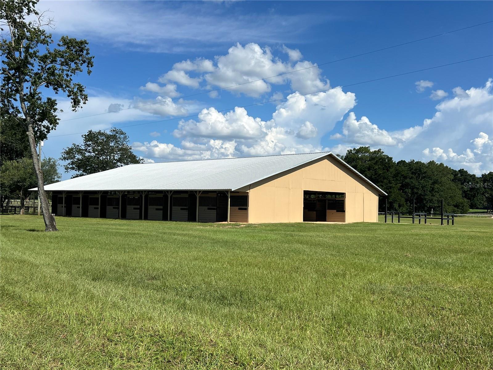 Spectacular farm for rent only 10 minutes from the World Equestrian Center and 15-minutes from HITS. This beautiful farm includes a large 29 stall barn with 12 grass pastures, 2 wash racks, RV hookups, a tack room, feed room, bathroom and grooming area. All stalls are 12x12 with plenty of air flow. The farm provides ample space for riding and training, with expansive grass areas suitable for setting up show jumps and dressage arenas. An ideal setting for event riders with cross-country jumps and a water hazard already in place. Additionally, renters enjoy exclusive access to a dedicated track and the sprawling 450 acres of scenic landscapes perfect for hacking. *Please note the track is not for TB racing or breezing. It is for sport horse exercising only! Also available for an extra fee, is a 1 bed, 1 bath studio apartment which includes turnout for 1 or 2 horses.