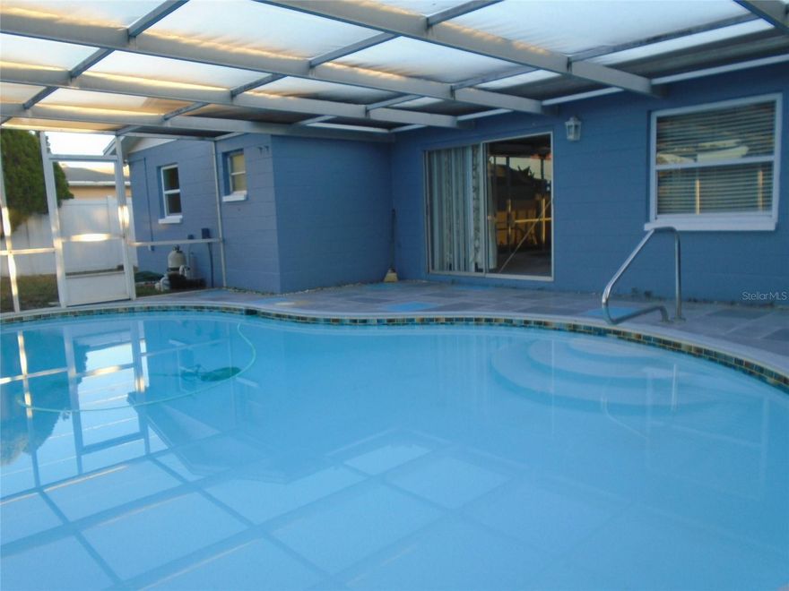 Pool Home — 3 Bed, 2 Bath Single-Family • Move-In Ready • Outside Flood Zone
 3-bedroom, 2-bath single-family pool home located outside the flood zone. Recently painted and well maintained, this clean home features tankless water heater and an  approximately 12-year-old roof in good shape, active Pasco County utilities, and an in-ground pool with full screen enclosure inside a fenced backyard — perfect for privacy and entertaining. Conveniently located near shopping, medical facilities and restaurants. 1-year home warranty included.