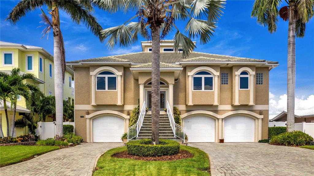 It is time to make your dreams of owning a luxury waterfront home a reality with this incredible property! There is no shortage of amazing water views and natural light in this home. An entertainers dream, the open floor plan continues to the outdoors when pocketing the 3 panels of sliding doors from the living room onto the 400 square foot patio. While being elevated, the home offers single level living with a split floor plan, formal dining room, wet bar and elegant kitchen. The kitchen is bright and inviting featuring high end appliances, granite countertops and even a dumbwaiter. The spacious master bedroom with calming water views, has its own access to the patio, a custom walk in closet and ensuite with individual vanities, jetted tub and separate shower. The two primary guest rooms on the opposite side of the home share a full bath. The 4th bedroom is currently used as an office and allows for many uses depending on your individual needs. This home embraces the idea of true Florida living, with a sparkling pool and outdoor kitchen. It is a boater's dream with your own boat dock and 8000 lb lift. You are under 10 minutes by boat to John's Pass and the open waters of the Gulf. With 3 garages, there is room for all your vehicles and toys. Treasure Island is centrally located and is always at the top of the most desirable beaches and communities. This home is NOT TO BE MISSED! Come envision your new beginning today. Room Feature: Linen Closet In Bath (Primary Bathroom).