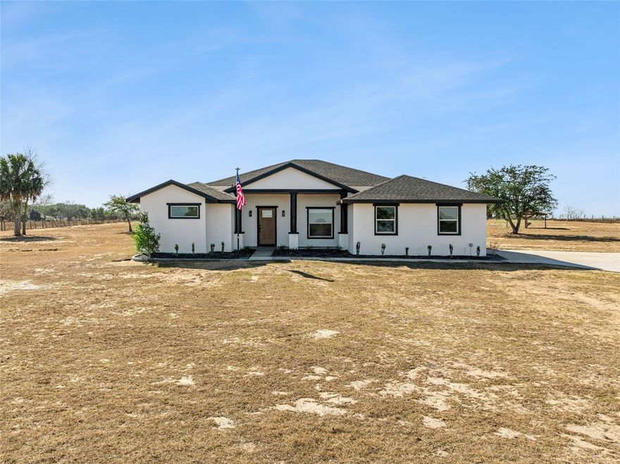 Come and live your own Magnolia Dream in this beautifully renovated farmhouse located on almost 5 Acres of cleared, HIGH and DRY property.  This home is almost brand new!  Stunning curb appeal with the Crossed Fence and Gated front entrance into your estate, drive to your home on concrete driveway.  All of the land is FULLY fenced offering peace of mind.  Enter into this home and be WOWED with it's high ceilings and stunning views.  The NEW kitchen is SO dreamy, with tons of storage, a impressive kitchen island with seating and lots of counter space.  The kitchen cabinets are solid wood with soft close drawers.  There is are impressive upgrades such as a pot filler above the smooth cooktop, handsome Kitchen Stainless Steel Hood and extraordinary pendant lights.  All of the appliances are BRAND NEW and includes a Washer & Dryer.  You will LOVE the living room, with a marvelous stone fireplace with custom built in's.  The Master Suite is alluring with enough space in the bedroom for a sitting/lounging area.  The Master Bath is AMAZING!  Double vanities, built in linen closet, custom BATH TUB and walk in shower.  The home also features a nice front porch for your rocking chairs and HUGE Screened in Back Porch with Shiplap ceiling overlooking your beautiful land.  The Garage Floor has a striking epoxy floor, perfect for you!  New ROOF, NEW A/C. New Blown in Insulation.  Brand New Waterproof Laminate Flooring, New Exterior & Interior Paint, New Ceiling Fans & Custom Lighting, New Window Blinds and much more!  This location is AMAZING, approx 14 minutes away from the Turnpike on HWY 27 for an easy commute to Orlando.  It's just a minute away from North Hwy 33 so traveling to Leesburg, Groveland, Clermont or Sumter County is very quick!