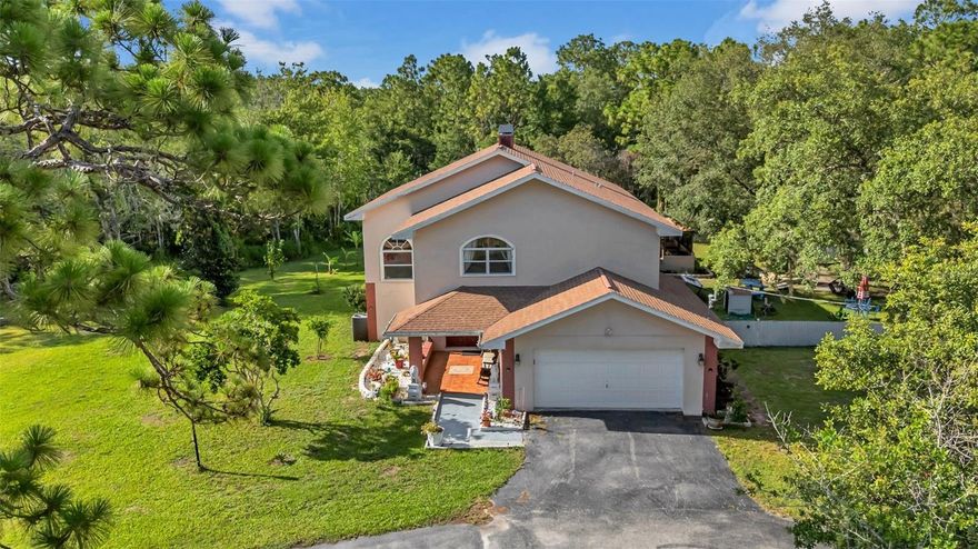 Charming 4-Bedroom Pool Home on 4.30 Acres with Detached 1,821 Sq Ft Garage/Workshop, New Water Heater, No HOA/CDD & Zoned Agricultural! Experience the best of Florida country living in this beautifully updated 4-bedroom, 2.5-bath pool home nestled on 4.30 acres of private, landscaped land. Inside, enjoy an open, spacious layout with a modern kitchen and plenty of room for everyday living and entertaining. Step outside to your screened-in pool and outdoor area—perfect for year-round gatherings. The property features mature fruit trees and wide-open space to roam, garden, or relax. What makes this property truly special is the detached 1,821 sq ft garage/workshop with electricity, ideal for car collectors, hobbyists, small business owners, or serious storage needs. An attached 2-car garage adds everyday convenience. Zoned agricultural with no deed restrictions, you're free to bring your horses, chickens, RV, boat, and all your toys. Whether you're looking to start a mini homestead or just want space to spread out, this is the lifestyle upgrade you’ve been waiting for. With no HOA or CDD fees, enjoy total freedom in a peaceful setting—just a short drive to schools, shopping and dining. Conveniently located near: Hudson Beach/Sam's Beach Bar – 11 minutes, SunWest Park – 7 minutes, Weeki Wachee Springs – 17 minutes, Werner-Boyce Salt Springs State Park - 15 minutes, Tarpon Springs – 40 minutes and Tampa International Airport - 50 minutes. Don’t miss this unique opportunity to own a one-of-a-kind property that offers space, freedom, and the lifestyle you’ve been dreaming of.