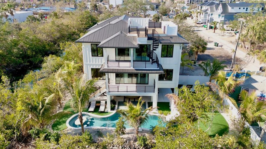 Discover the ultimate expression of luxury coastal living in the heart of Siesta Key. This extraordinary 9-bedroom, 9.5-bath property is a true architectural showpiece, offering unmatched space, style, and sophistication just moments from world-renowned beaches and vibrant island amenities.

Designed with an emphasis on grand-scale living, the home features an expansive great room floor plan that blends effortless comfort with refined elegance. The chef’s kitchen is a standout centerpiece, showcasing a large center island, premium appliances, and an oversized walk-in pantry. Perfect for both everyday living and large-scale entertaining.

The dining area is enhanced by custom lighting, creating an inviting ambiance for memorable gatherings. A private elevator provides seamless access to all levels, while the 3-car garage adds convenience and storage flexibility. On the third floor of the home find an additional open family living room space with a wet bar and separate outdoor patio. No detail has been missed including an incredible game room. 

Every inch of this turnkey furnished home is finished with high-end materials and thoughtful craftsmanship. With nine spacious en-suite bedrooms, this property is ideal for multigenerational living, hosting guests, or maximizing income potential as a luxury rental investment.

Outdoor living reaches new heights with a resort-style pool and covered spa, a super fun waterslide, and a putt-putt green are all within the interior of lush tropical landscaping. There are also plenty of outdoor dining and lounging options throughout with several patios and porches including an impressive rooftop deck which offers a panoramic view of the famous Siesta sunsets.

Top rated Siesta beach is just a short stroll away as well as shops, the marina and dining. Whether you’re seeking a full-time residence, a second home, or a premier investment opportunity, this Siesta Key BEACH HOUSE delivers an unparalleled blend of luxury, versatility, and island living at its finest.