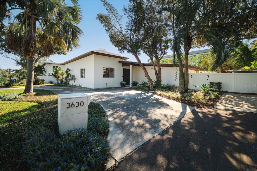 Beautifully updated South Tampa waterfront home just one lot from the open bay. This move-in-ready canal-front property offers 100 feet of seawall, a boat lift and a new composite dock for quick access to Tampa Bay. The open floor plan features soaring ceilings, oversized porcelain tile and a modern kitchen with KraftMaid cabinetry, marble countertops, stone backsplash and all-new appliances. The primary suite includes 12-foot ceilings, custom closet, an oversized soaking tub, frameless glass shower and double vanity. A split layout provides two additional bedrooms, one en suite, plus a den or office. The home sits on an oversized lot with professional landscaping, a saltwater heated pool and spa, turf area and privacy fencing. Recent 2025 upgrades include new porcelain wood plank tile in bedrooms, baseboards, interior doors, wood trim, cabinetry in kitchen, all baths and laundry room, custom closet systems, new washer and dryer, and a new water heater. Enjoy sunrise coffee or sunset evenings overlooking the canal and open bay. This is the ideal South Tampa home for anyone seeking luxury, boating access and coastal living, all within minutes to downtown Tampa, Tampa International Airport, and some of the best shopping and dining South Tampa has to offer.