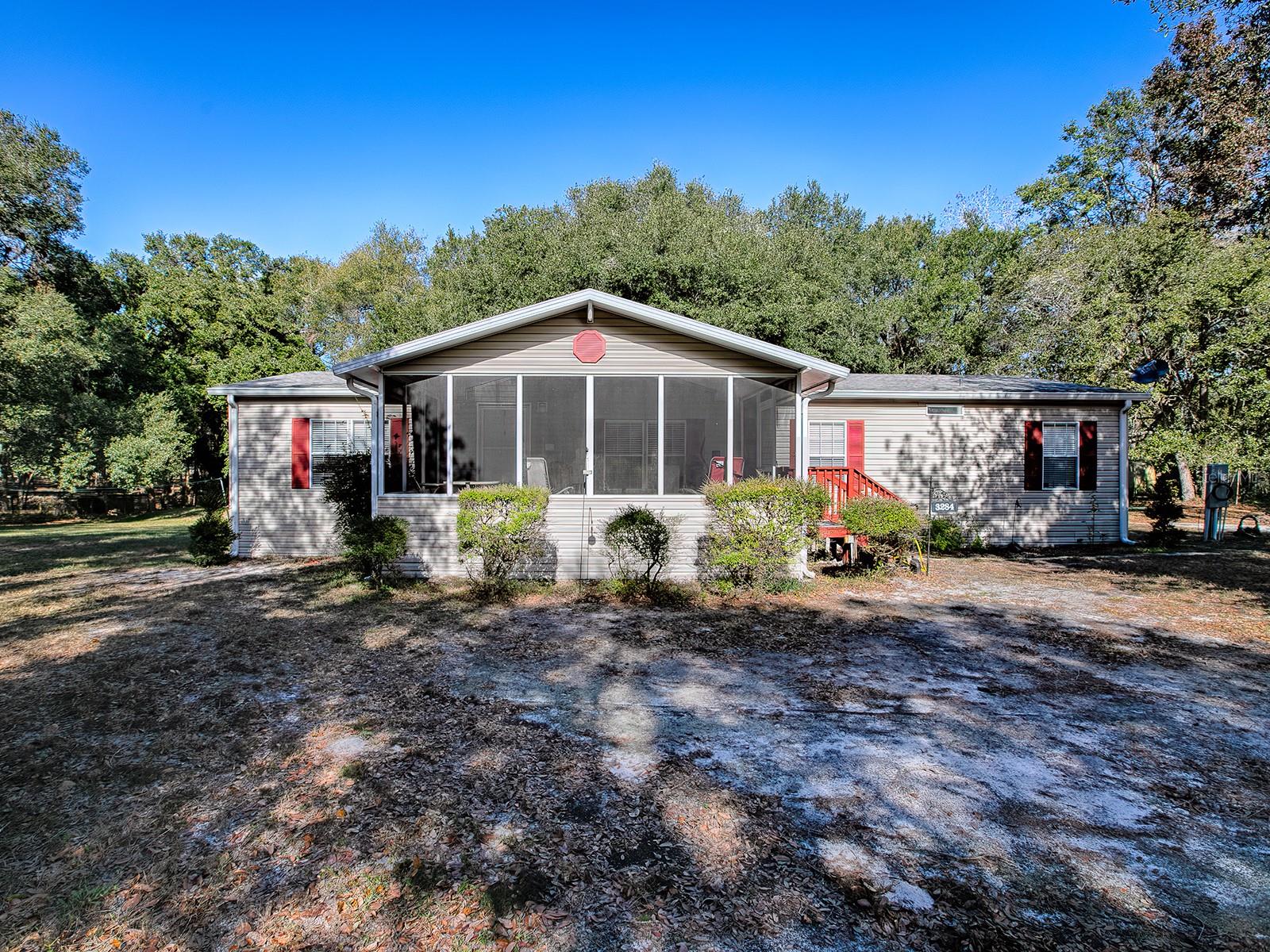 Seller has settled on the next spot to call home. Price adjusted for a quick sale. Single owner, Homes of Merit, impeccably well kept and maintained. Update the floors, maybe a little paint, and you have a great home on 10 acres. 330x1350, it kind of feels like the land goes on forever. Fully fenced and cross fenced. Modest 3 stall pole barn that gets the job done. Attached feed room. 8x12 storage shed and workshop, with electric. Tucked off the beaten path but within a stone’s throw from all the latest The Village’s will have to offer. 3 bedrooms, 2 bathrooms, 1620 sqft double wide mobile home. Living room, open kitchen hen, and family room. Split bedroom layout. Inside laundry, with closet pantry. NO HOA. No deed restrictions. Farm, play, invest in your future. Screened front porch. Underground electric. Owned water softener systems, not leased. Septic was pumped and new drain field installed per seller in 2022. HVAC replaced per seller 2016. New roof per seller in 2016. Your land, your rules. One hour from Orlando and Tampa. One hour from The World Equestrian Center, and minutes from the Villages. Seller’s are packed and ready to make a deal. This could be your home by the end of the month. Very easy to show but by appointment only. Please do not cross the gate without your Realtor and an appointment. We are thrilled to showcase this home and would love to show it to you. Call today.