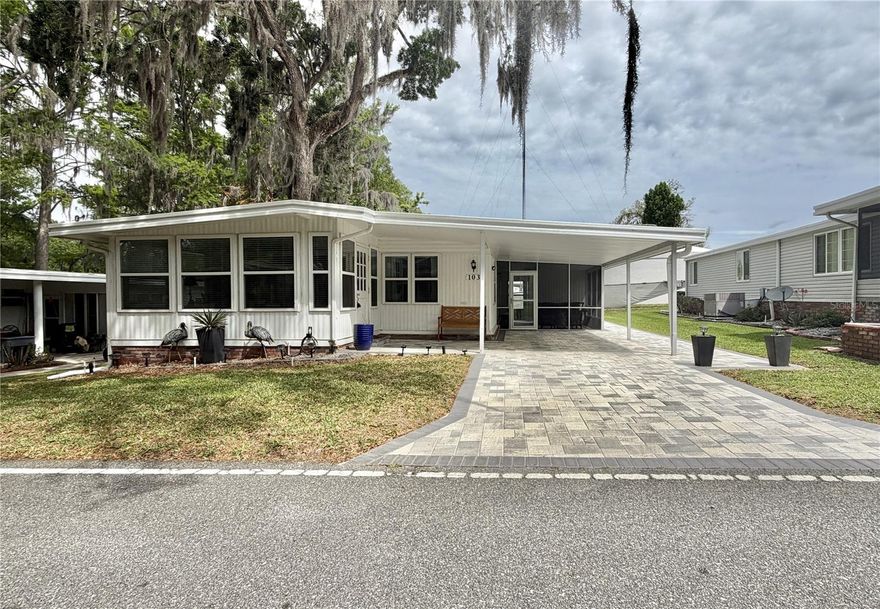 Welcome to 103 Royal Palm Drive. A warm, welcoming retreat where comfort meets thoughtful design and every detail has been carefully considered. Offering 1,312 square feet of beautifully updated living space, this charming 2-bedroom, 2-bath home invites you to slow down, settle in, and truly enjoy where you live. A beautiful paver driveway creates excellent curb appeal from the moment you arrive and continues seamlessly along the side yard to the back porch, providing both style and functionality. The home’s exterior vinyl siding adds to its attractive appearance while providing durability and low-maintenance living. Just beyond, a welcoming Florida room entry sets the tone, an inviting space filled with natural light that’s perfect for greeting guests, enjoying your morning coffee, or simply easing into the day. From there, step inside and feel the difference. The solid, upgraded subfloors and stylish luxury vinyl plank flooring (2022) create a sense of quality underfoot, while natural light pours through brand-new windows (2023), giving the home a bright and airy feel. Updated lighting with dimmers (2023) allows you to set just the right mood. At the heart of the home, the kitchen is designed to bring friends and family together. Featuring rich solid wood cabinetry with convenient pull-out shelves, stainless steel appliances (Refrigerator 2025), sleek Corian countertops, it’s a space that’s as functional as it is inviting, perfect for everything from morning coffee to holiday gatherings. Thoughtfully placed pendant light fixtures hang above the peninsula and over the sink, adding both style and warm, focused lighting to the space. The spacious primary suite offers a peaceful escape, complete with a custom-built walk-in closet and a beautifully updated en-suite bathroom featuring a walk-in shower for comfort and ease. The guest bathroom includes a tub, thoughtfully designed to accommodate both relaxation and accessibility. (Both bathrooms are ADA compliant.) Step outside and discover even more to love. The large, screened porch is perfect for morning breezes or evening conversations and beyond it, a private wooded backyard offers a serene, natural setting with added privacy, making it the perfect place to unwind. With major updates already completed, including a membrane roof (2005) with new trim (2023), HVAC system (2019), and tankless water heater (2016), this home offers not just beauty, but peace of mind.................Hawthorne at Leesburg is an active, resident owned, 55+ cooperative, waterfront, gated community, with beautifully landscaped grounds, lakes with illuminated fountains and a relaxing and comfortable gazebo. The affordable monthly maintenance fee of $397 includes water, sewer, lawn mowing, private emergency services and storage space for recreational vehicles, boats, trailers and much more! The beautiful clubhouse is complete with a full-time program coordinator, more than 100 different activities and seating for 550. It has a hospitality lounge, card rooms, craft rooms, billiard room, fitness center, library, fine arts room and many more. There is excellent fishing, outdoor geo-thermally heated pool and two enclosed therapeutic pools. Hawthorne boasts a private marina monitored by an electronic security system with over 120 boat slips and access to the Harris Chain of Lakes and beyond.