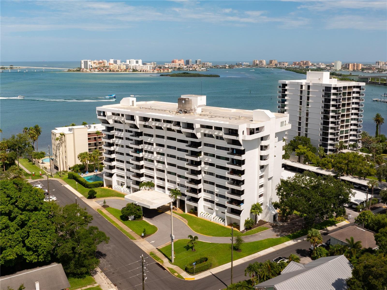 MOVE IN CONDITION and a water view! This beautiful seventh floor condo offers two large bedrooms and two full bathrooms and is located in one of Clearwater's most desirable communities - Harbor Oaks Place. The primary bedroom suite is so comfortable with its generous size and ensuite bathroom and two closets. The second bedroom also is quite large and the second bathroom is just across the hallway. Both bedrooms have an abundance of natural light streaming from the south. There are solid wood cabinets throughout the home. The kitchen has granite counter tops, a tumbled marble backsplash with an inlay over the sink and a glass tile listelo plus a Brand New Stainless Steel appliance package. The kitchen has soft close doors and drawers and a closet pantry and under cabinet lighting. The Dining room is open to the Living Room and both have wood flooring and custom crown molding. The living room quad sliding doors lead to the balcony with its southwest view of the water. The ceilings are more than 8 ft high and there are extra closets along the hallway plus a walk in closet and a Tankless Water Heater. Come enjoy the heated pool, sauna, waterside park with fishing pier, billiards room, workout room, library and social room. These is a car wash area and a designated pet area. This amazing property is just a few minutes walk to downtown Clearwater with your choice of restaurants, concerts, etc. Nearby you will find pharmacies, grocery stores, Morton Plant Hospital and so much more.