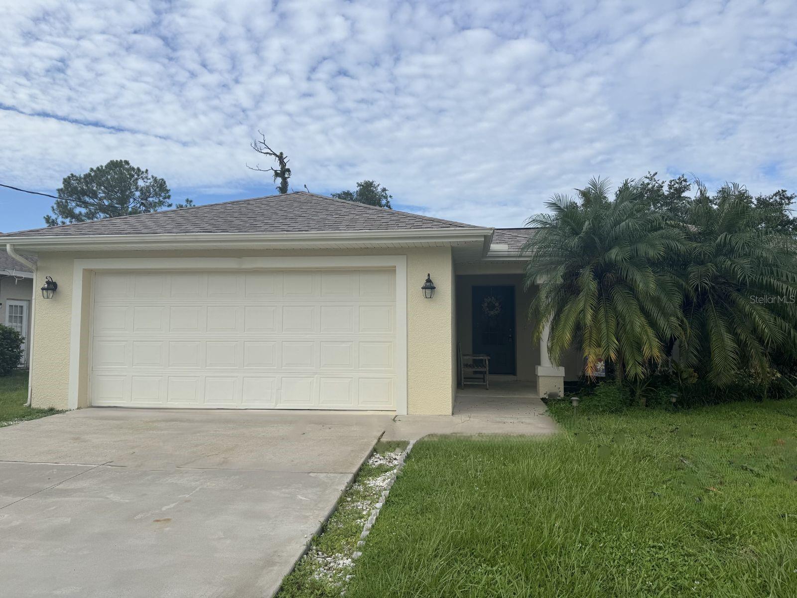 Sweet Renovated North Port home with fenced backyard, no HOA. This open-layout house features a new kitchen with stainless steel appliances, all-new cabinets, and a large pantry. The Great Room has cathedral ceilings and tile floors throughout. Sliding doors from the dining area lead to a spacious screened lanai and a large patio. The private backyard is fully enclosed with a white resin fence. The split floor plan provides a master bedroom with a walk-in closet, dressing mirror, ceiling fan, and a renovated modern bath with a glass shower and new fixtures. Two guest rooms have ceiling fans and closet shelving; the guest bath includes a tub/shower. Additional highlights: new roof, inside laundry room with washer/dryer, two-car garage with hurricane struts, extra fridge, and wash tub. Monthly fee covers lawn care and pest control. Small pets under 15 pounds are allowed with a non-refundable fee.