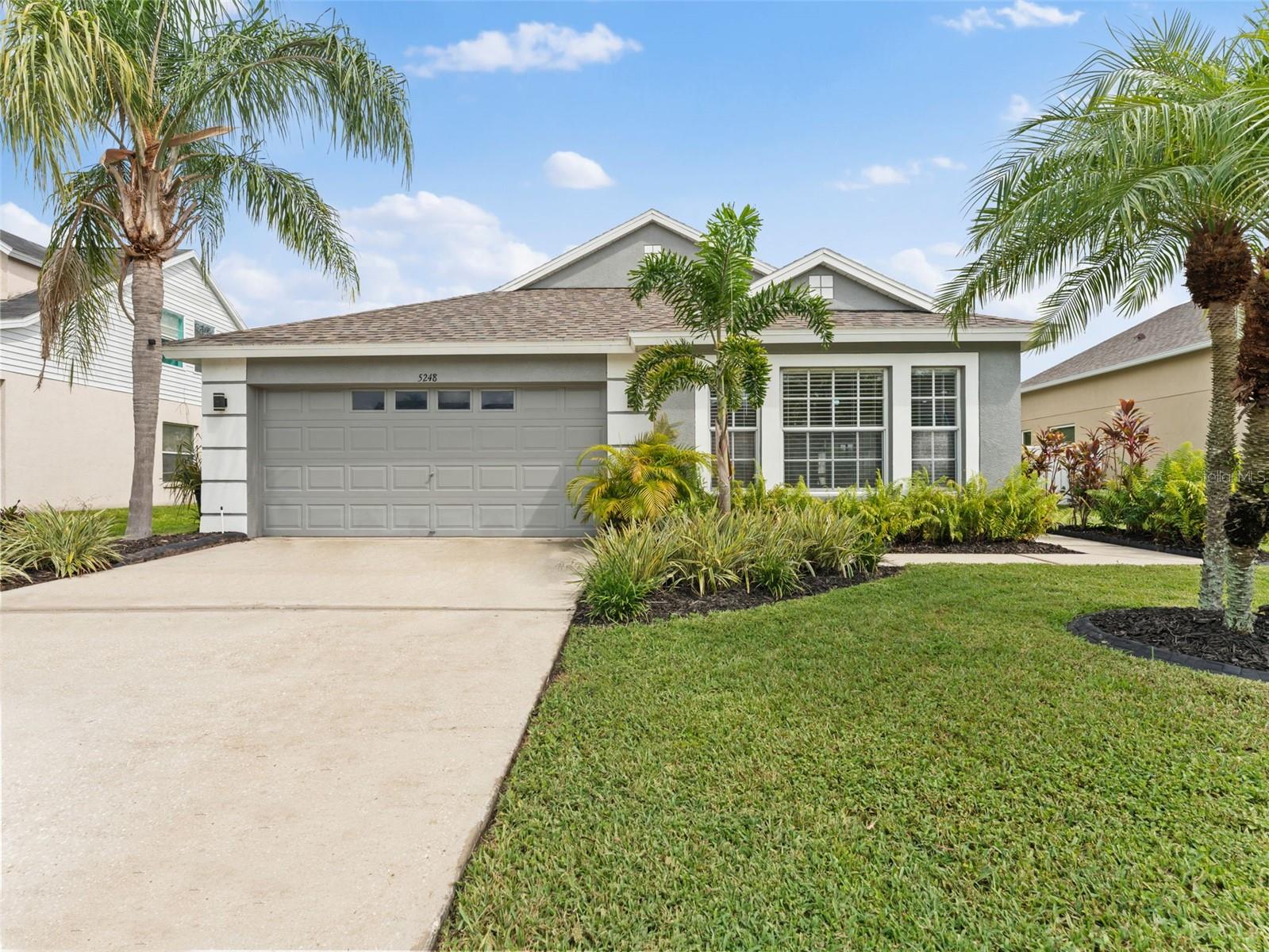Welcome to New River Lakes in highly sought after Wesley Chapel. This waterfront home in The Estates features a spacious fenced yard suitable for gardening, a swing set, and more. This well-maintained home includes 3 bedrooms, 2 bathrooms, a 2-car garage, a combined living and dining area, a bonus room, an indoor laundry room, and a 15x9 covered back patio. Upon entering the home from the covered front entry, you will be greeted by a gorgeous and peaceful view of the lake, lush lawn and landscaped backyard. The kitchen is open to the living room and dining area making family time and gatherings easy and enjoyable. There is a 13x16 separate bonus/family room that would also be perfect for a formal dining room, office, playroom or theatre room. This is an open and split bedroom floor plan. The master suite showcases a beautiful professionally applied Anthropologie wallpaper mural, sliders to the back patio, walk in closet, a master bathroom with a dual sink vanity garden tub with shower and new flooring. The inside laundry room includes shelving and the washer and dryer 2021. There is lots of room to cook in this kitchen which includes an added butcher block counter, closet pantry and a new refrigerator and dishwasher. The fenced backyard overlooking the lake is the place to be with new sod Fall 2024, a family gathering area, privacy fenced sides, covered paver patio and a mature oak tree providing the perfect amount of shade. Features include AC (2021), roof (2021), exterior paint (2022), LVT flooring, new toilets (2023), blinds, ceiling fans, interior paint by professionals, irrigation and freshly mulched landscaping beds. No CDD and the low HOA includes access to the community pool, playground, basketball courts, tennis courts and Spectrum cable and internet. This area is booming with new developments, hospitals, shopping, entertainment, schools and recreation. Great location with easy access to Hwy 54 and I75. This move in ready and well cared for home is ready to welcome you to your new home.