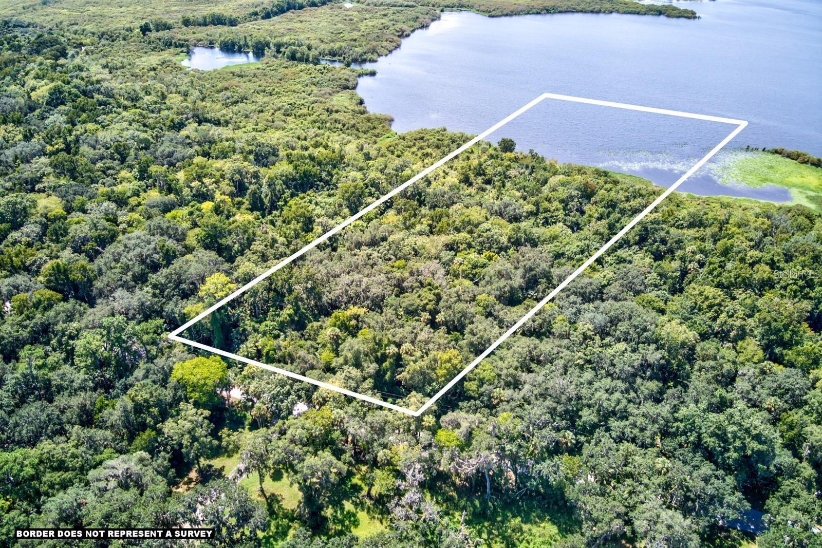 10.5 Acres of Direct Lake Monroe Waterfront – Build Your Dream Estate! Rare opportunity to own an extremely valuable 10.5 acres of vacant land for a GREAT DEAL directly on Lake Monroe in the charming town of Enterprise, just outside the sought-after Stone Island community. Enjoy panoramic lake views, stunning sunsets, wildlife, and sparkling nighttime views of Downtown Sanford. Ownership extends into Bethel Creek Cove with potential for your own private dock. Come with a VISION. Enjoy your summers with water-sports, boat days, fishing and more and make your home your very own Florida Oasis. This lot has all of the potential for you to build your DREAM HOME with plenty of room for barns, a pool, guest houses, or in-law suite, boats, RVs, 4wheelers, you name it. No HOA, with plenty of acreage to elevate construction and avoid flooding. Conveniently located near parks, trails, schools, I-4, 415, shopping, dining, and the growing downtown DeBary. You don’t want to miss this opportunity!